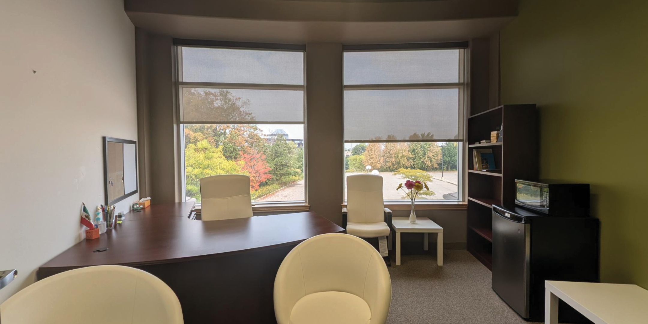 1250 Markham Road Office with two large windows and desk and chairs