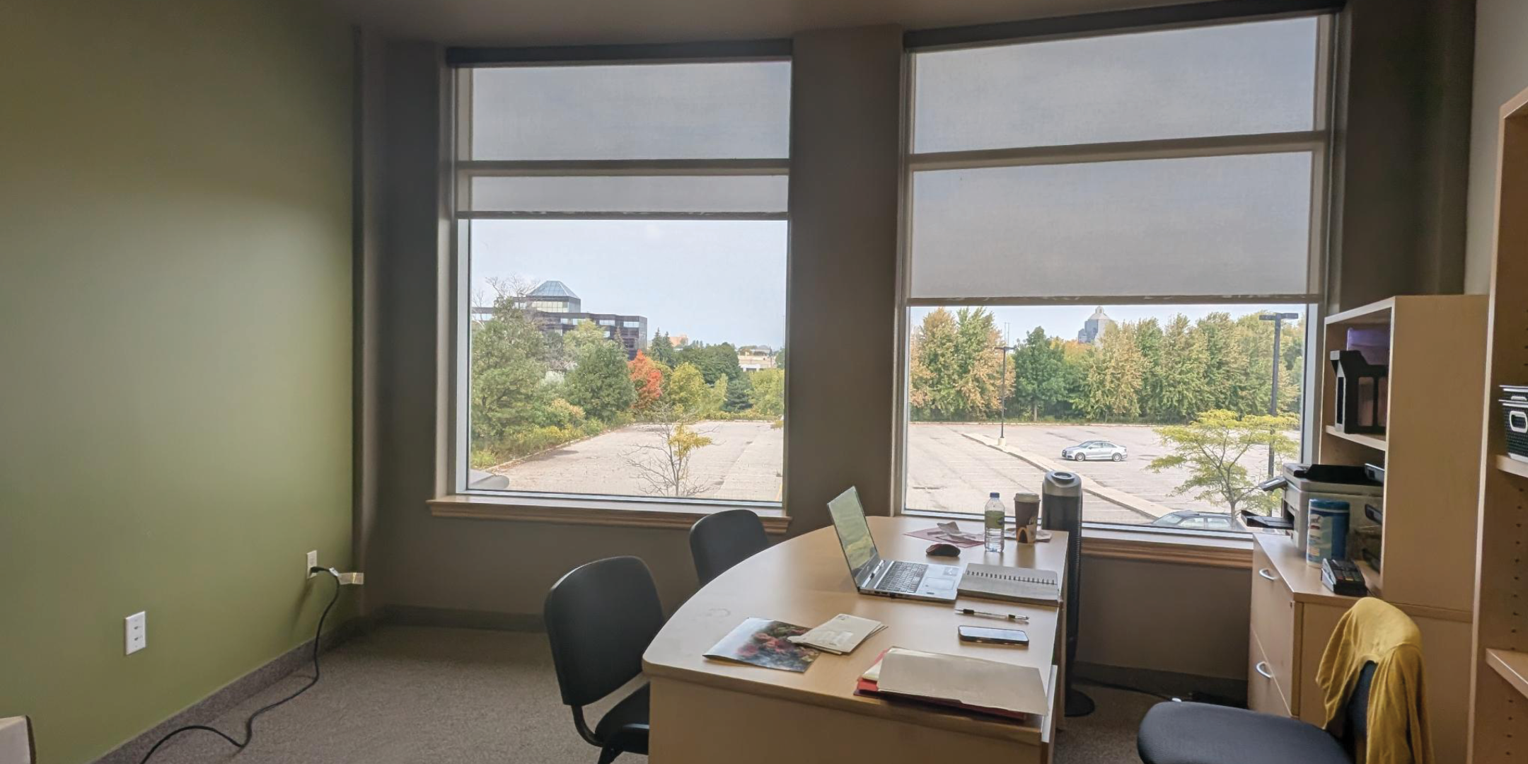 1250 Markham Road Office with two large windows and desk and chairs