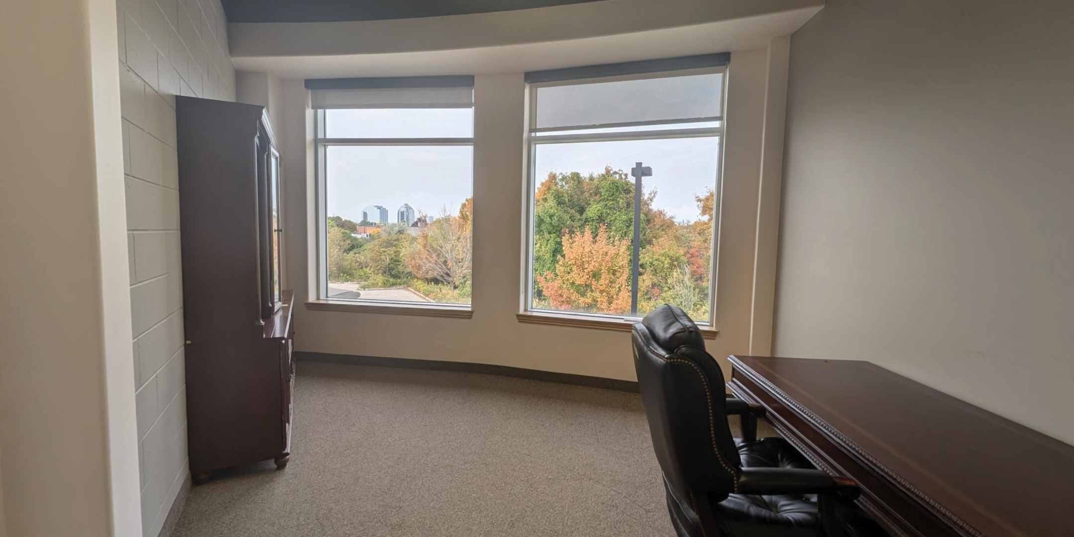 1250 Markham Road Office with two large windows and desk 
