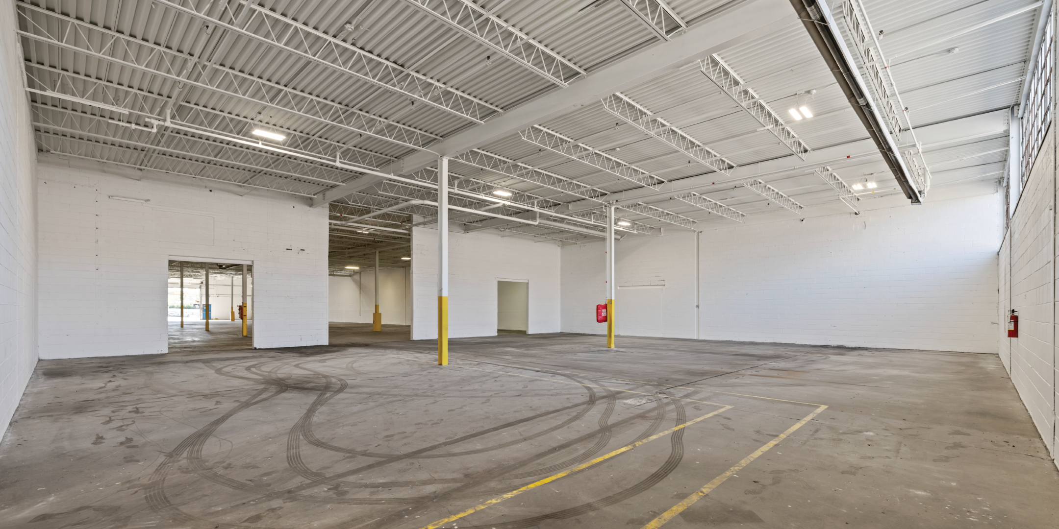 3636 Weston Road interior empty warehouse with concrete floors and white walls and windows long top of back wall