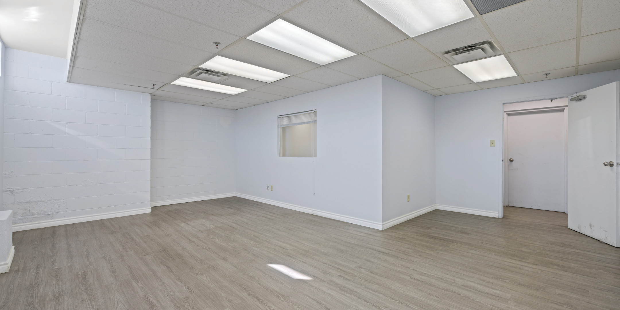 3636 Weston Road office with white walls, light wood floors, and suspended ceiling