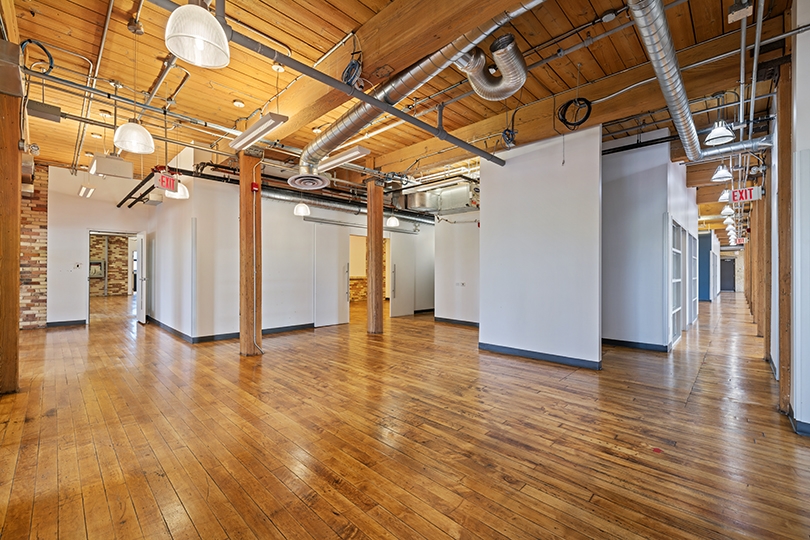 46 Spadina Avenue interior view brick-walled office with wood floors 