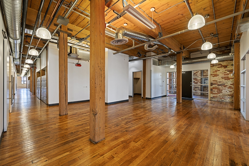 46 Spadina Avenue interior view brick-walled office with wood floors 