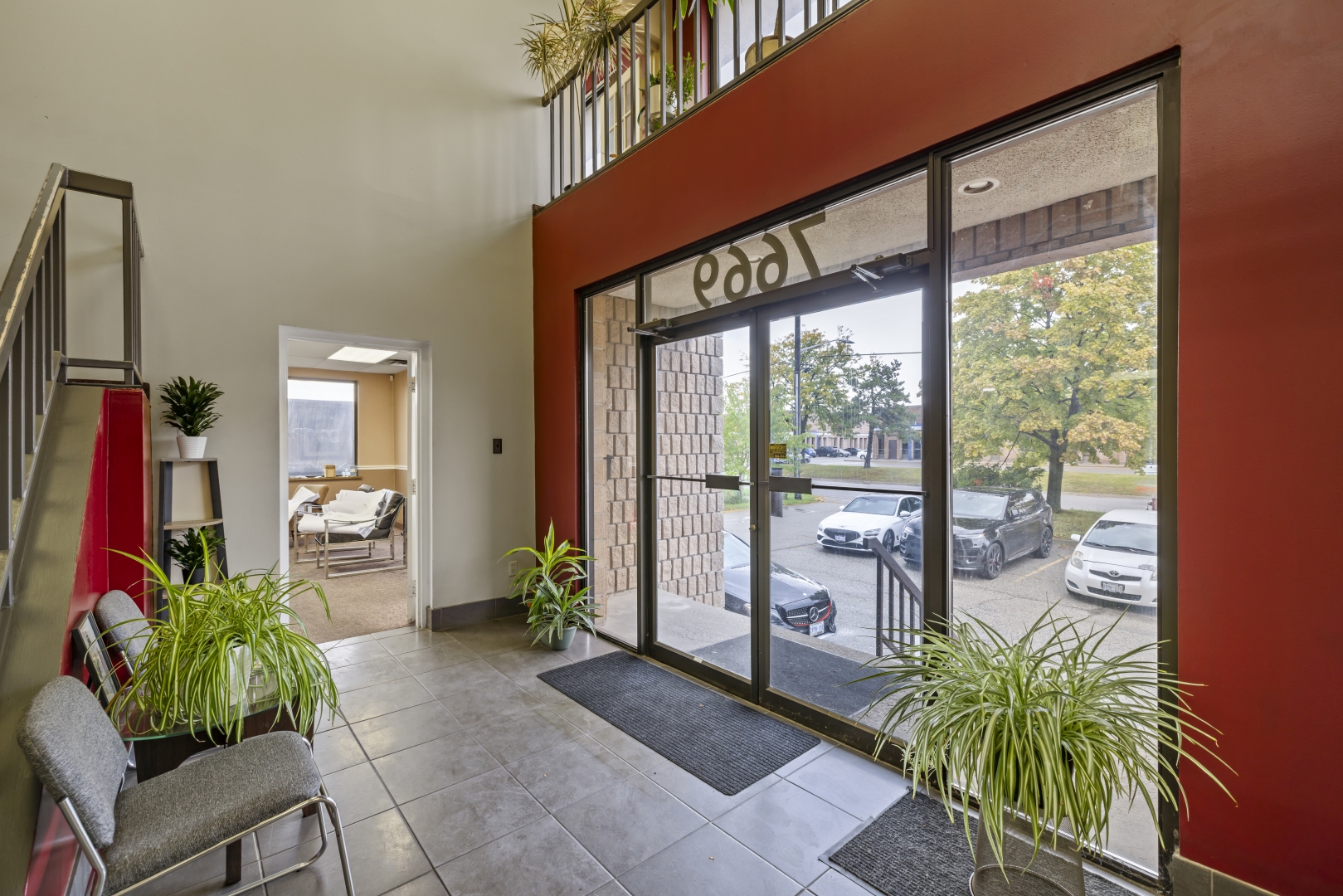 7669 Kimbel Street interior building front entrance, large glass doors and tiled floor looking out into the parking lot