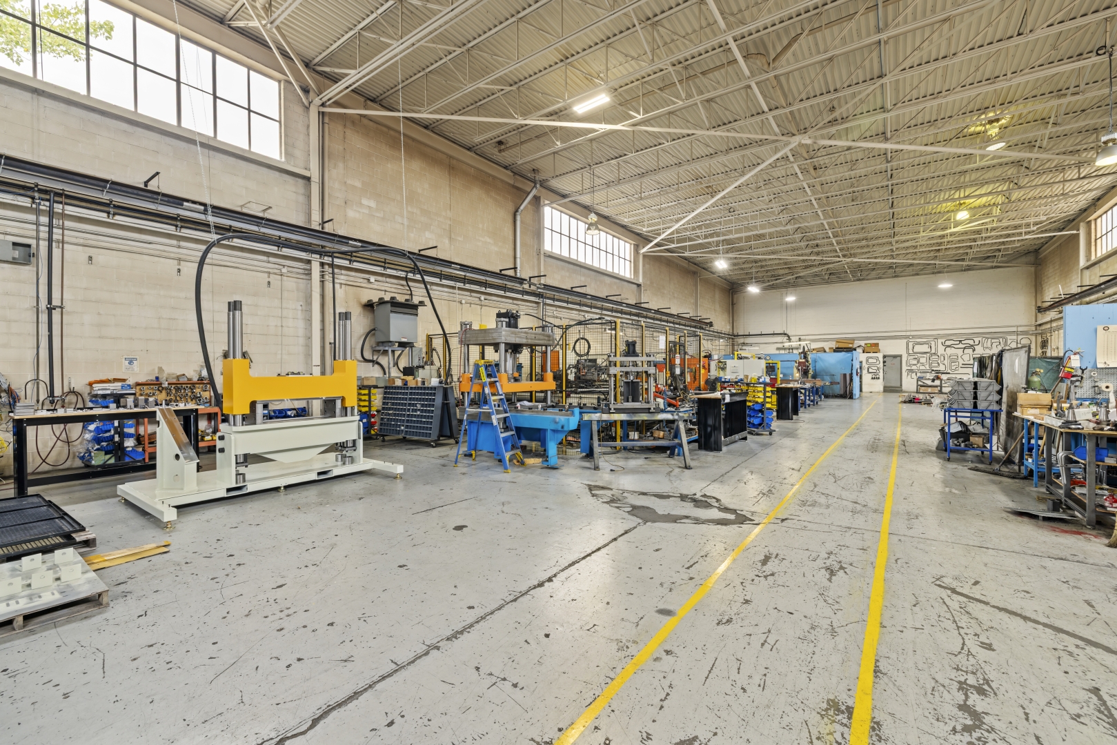 7669 Kimbel Street interior two storey warehouse with concrete floors and windows along the top edge of the wall 