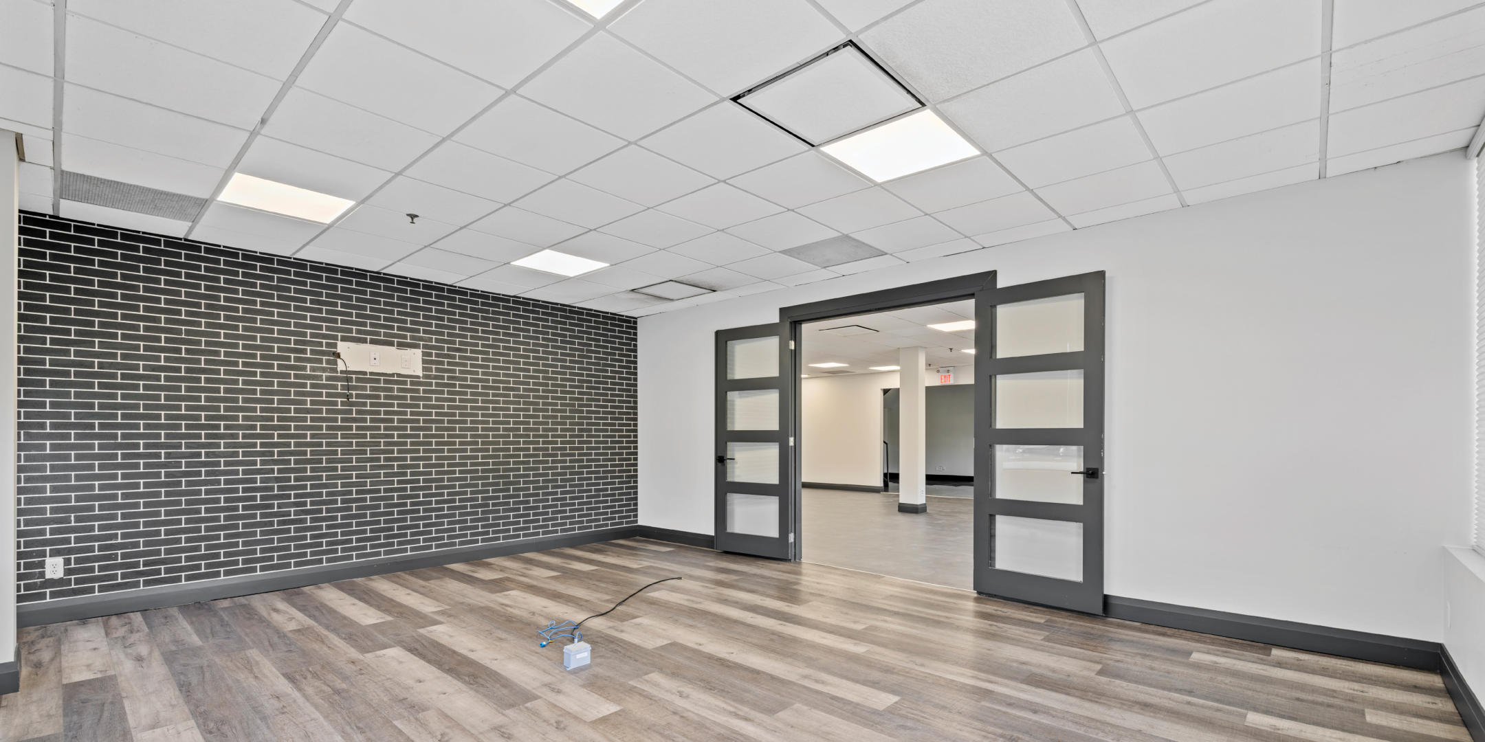 8 Abacus Road Office Space with wide doorway, black accent wall and hardwood floors
