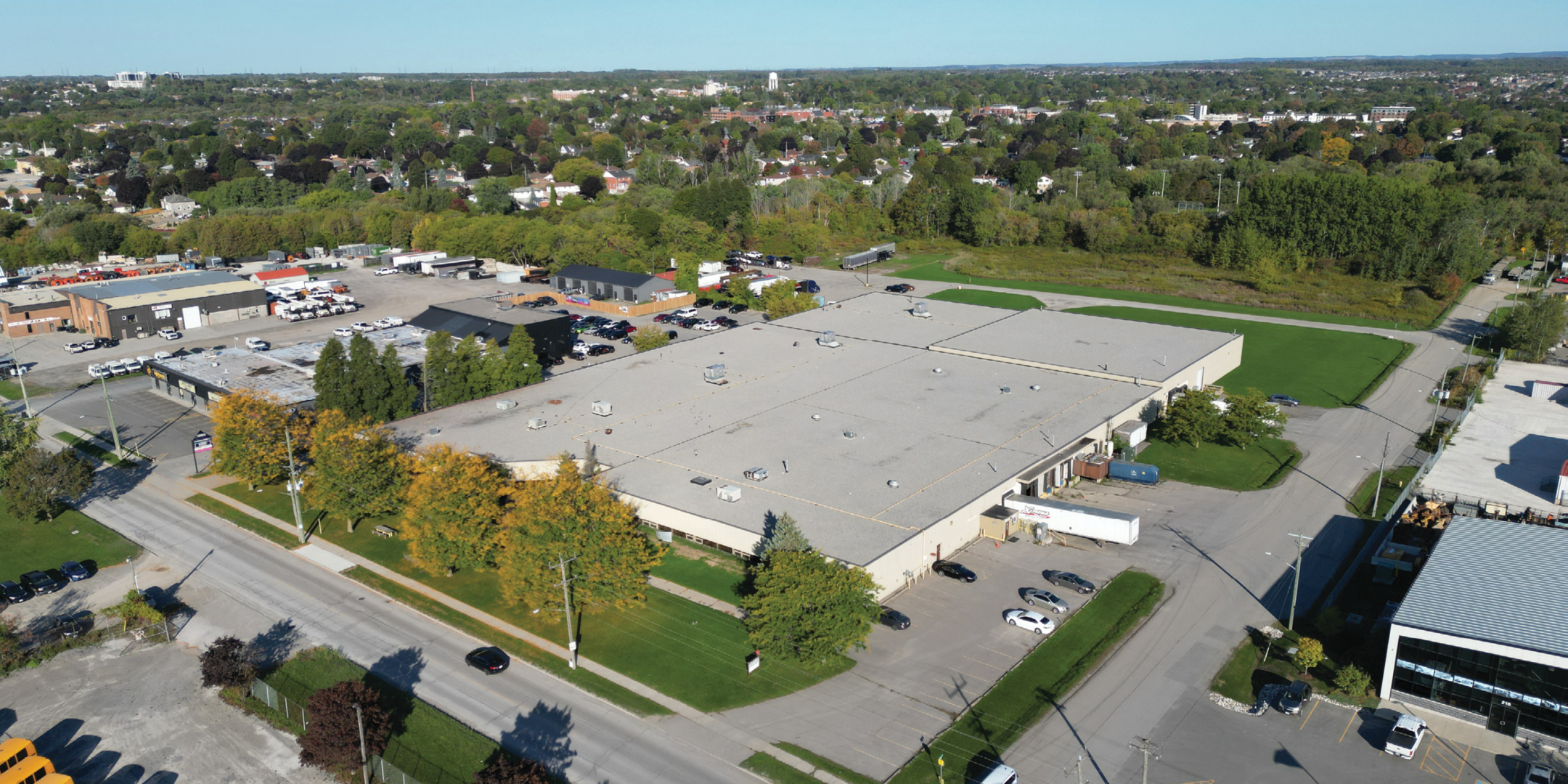 Aerial view of front of grey industrial building