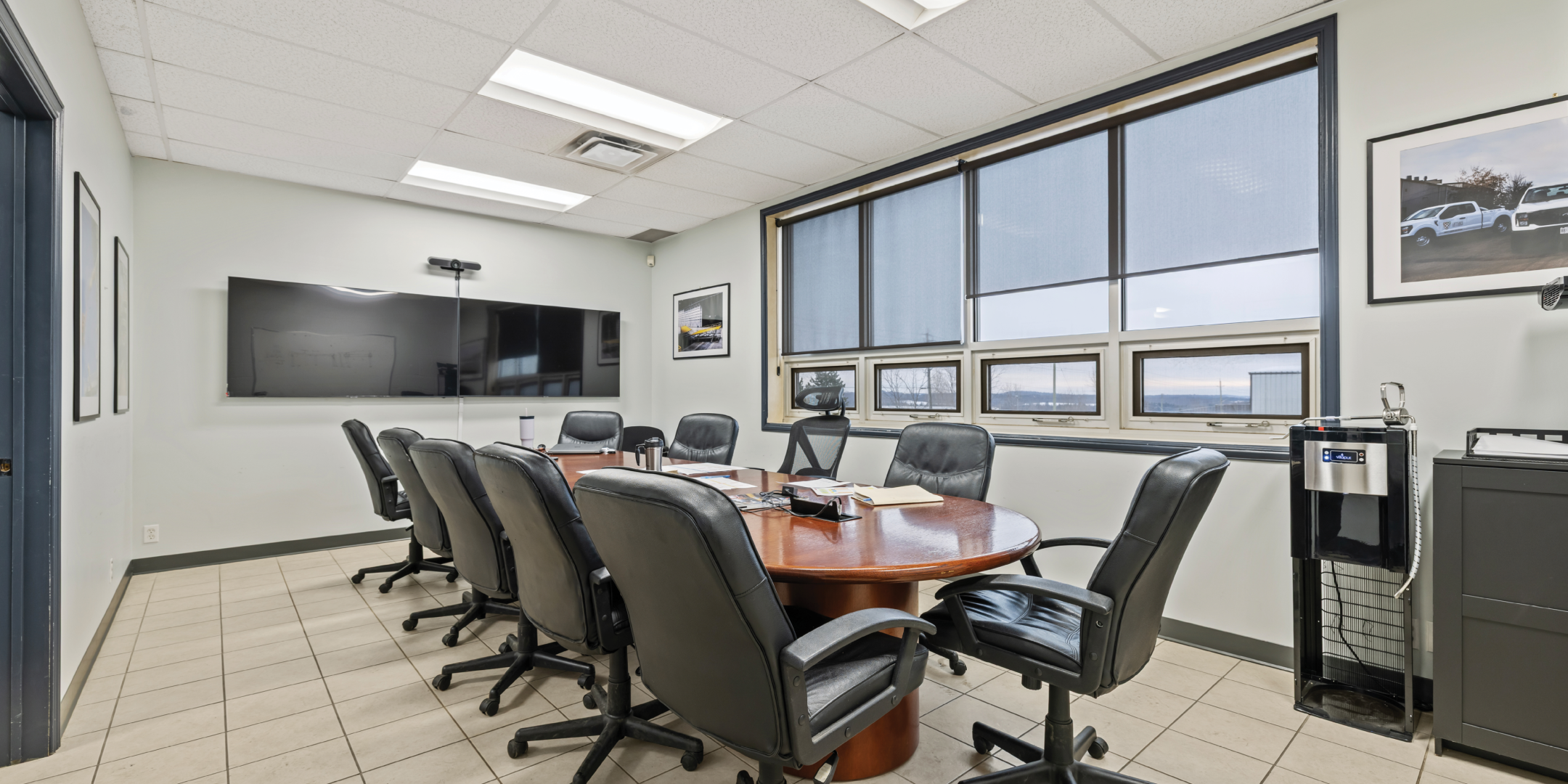 Meeting room with large desk and TV monitors