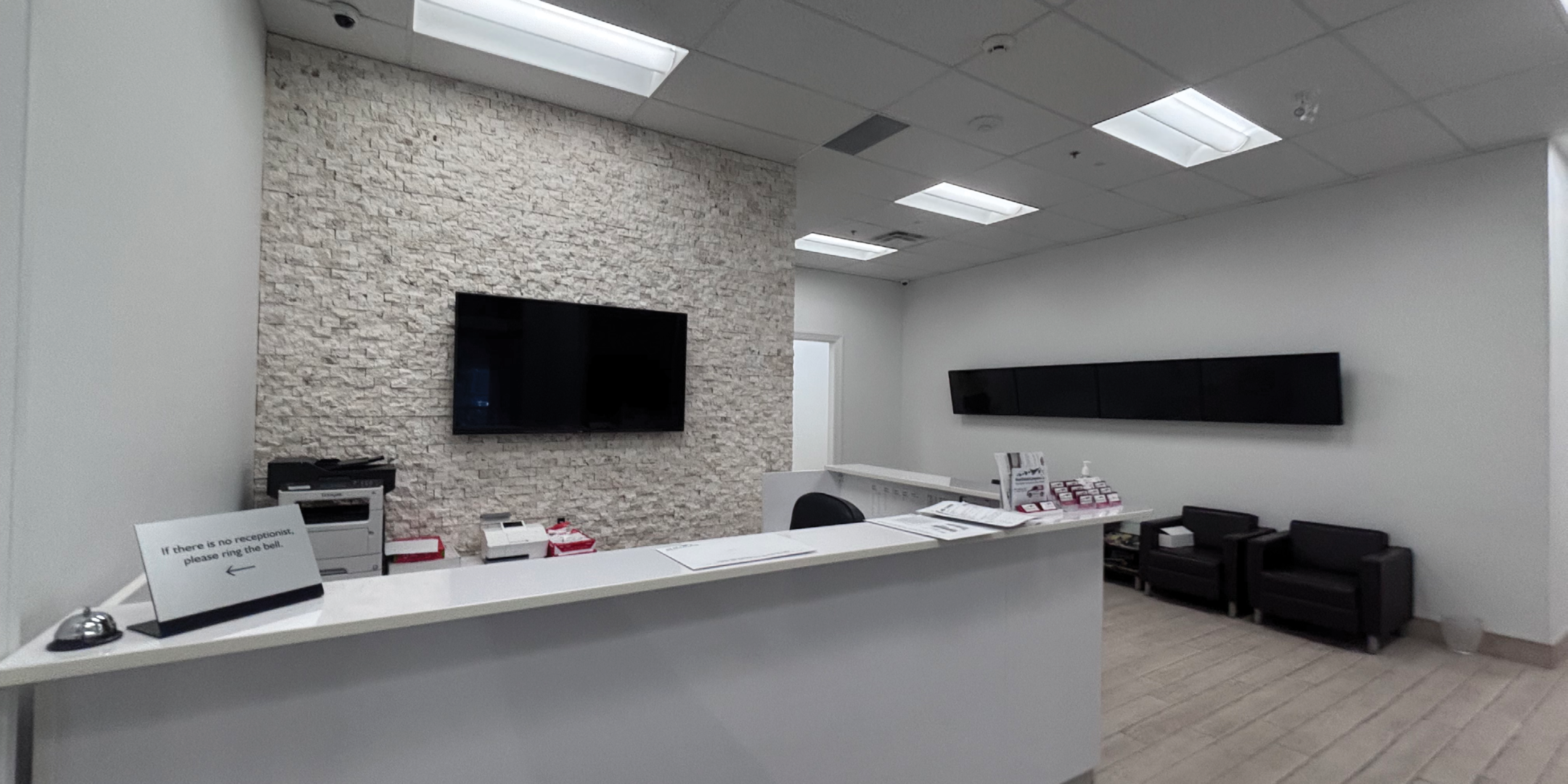 Reception area with white walls and grey brick accents