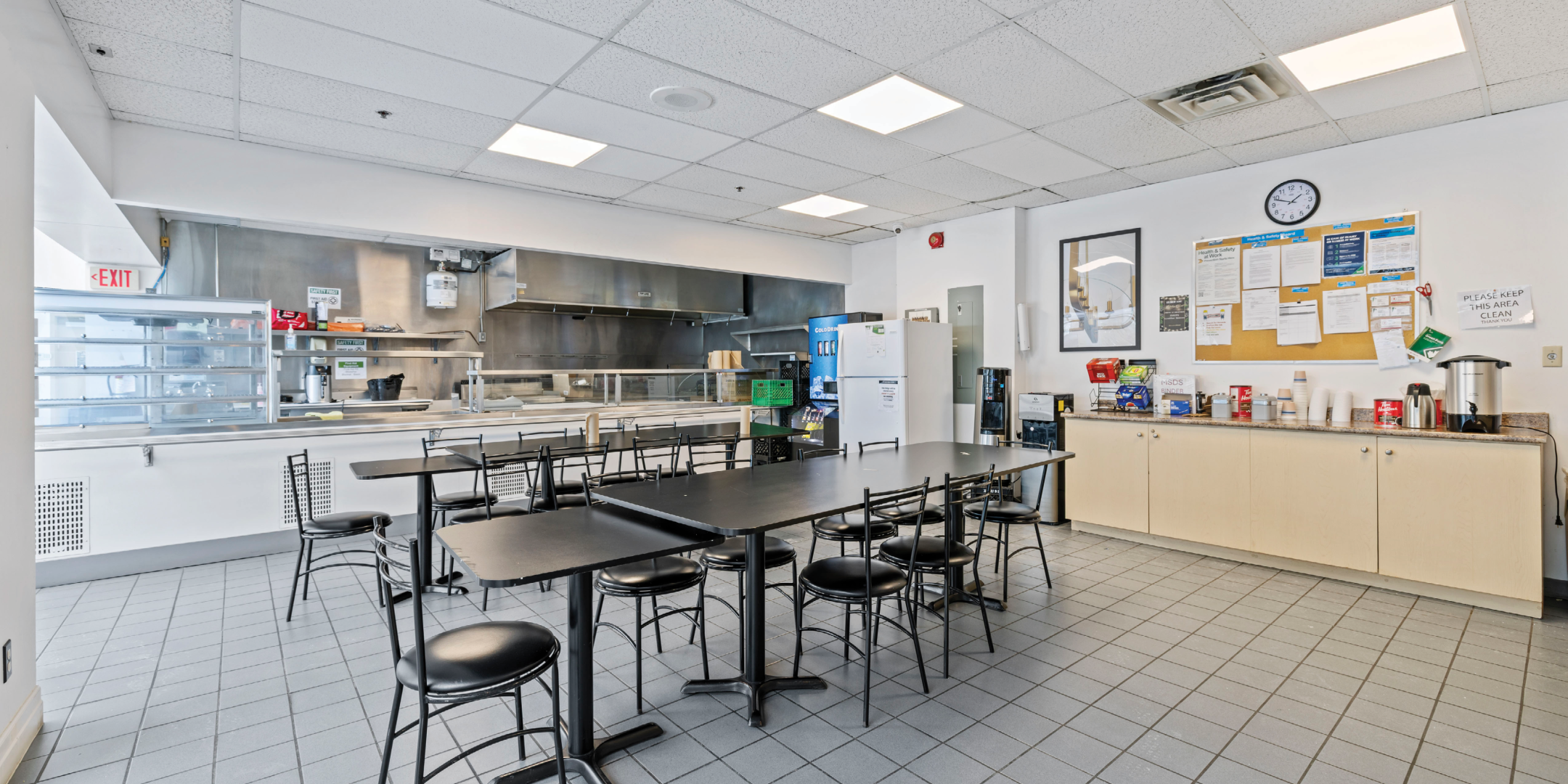 kitchen area with tables and cafeteria setting