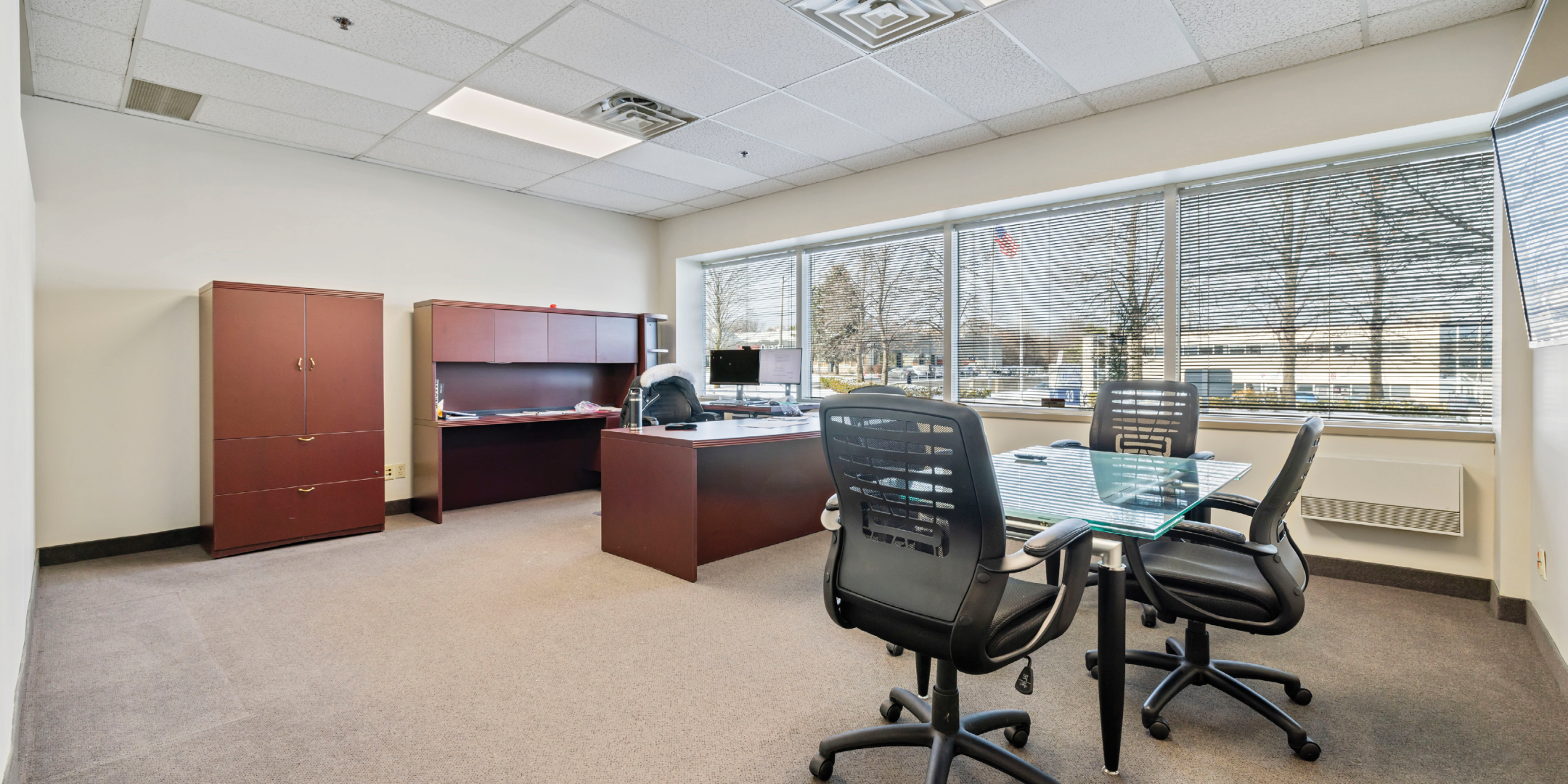 large office with desk and side table and chairs