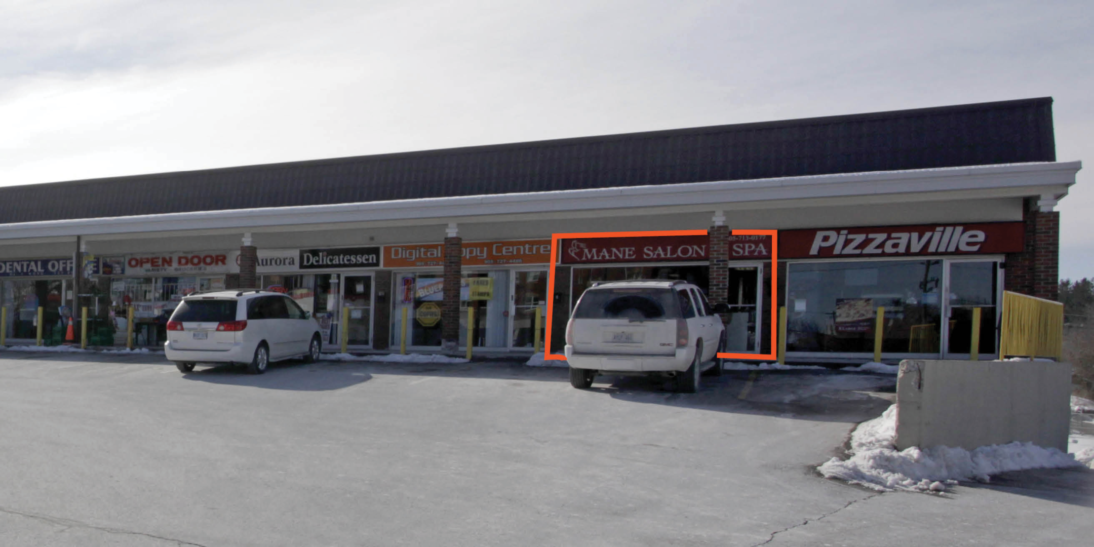 Photo of front entrance of salon unit in multi unit outdoor strip plaza