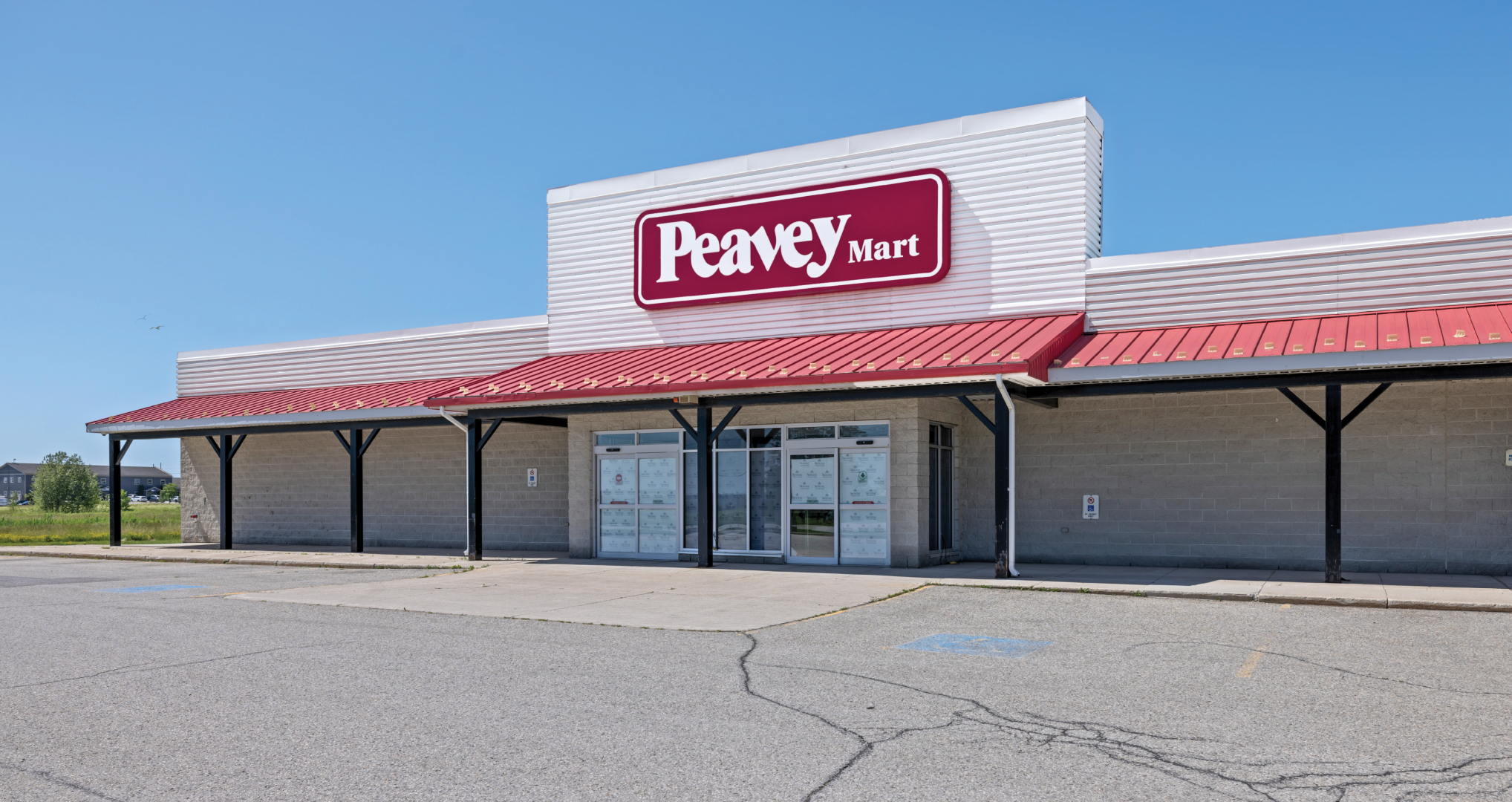 Entrance of vacant retail building formerly home to Peavey Mart