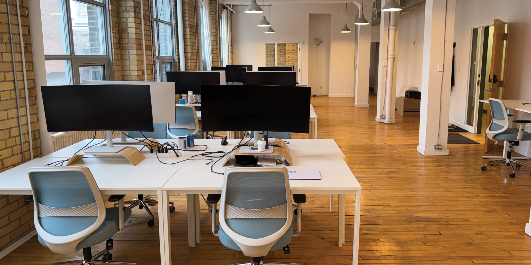 174 Spadina Avenue interior view of the open workstations with desks and monitors
