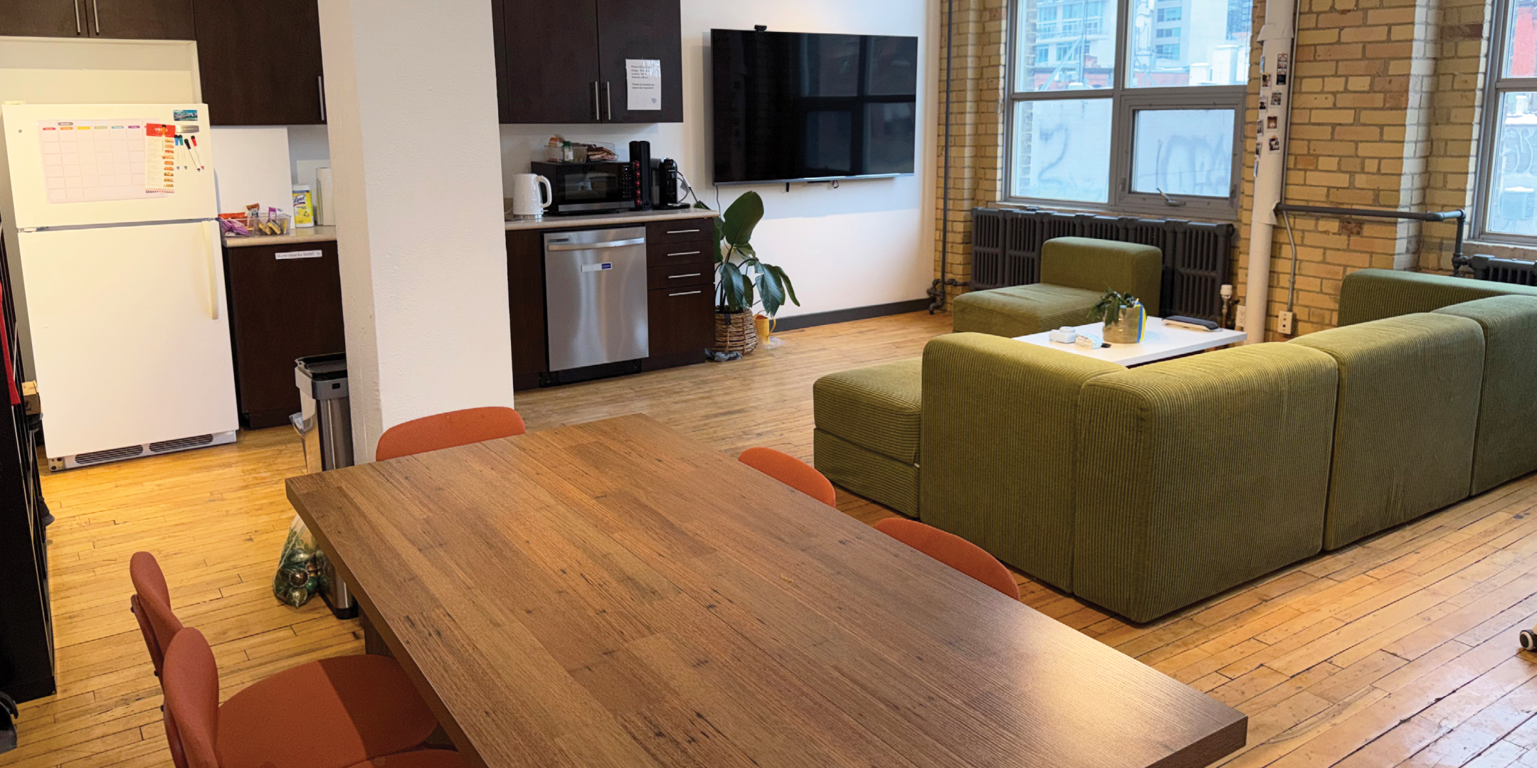 174 Spadina Avenue interior view of the dinning area with sofa and fridge