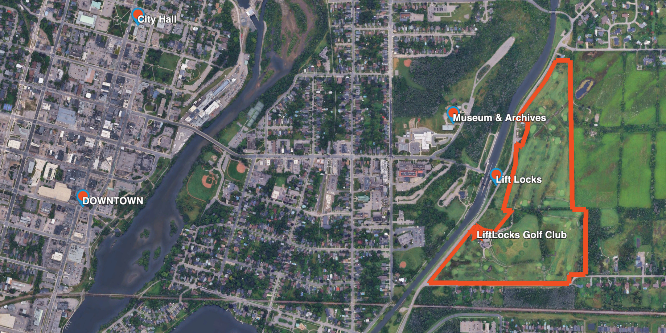 birds eye aerial of golf course showing river and lakes in background