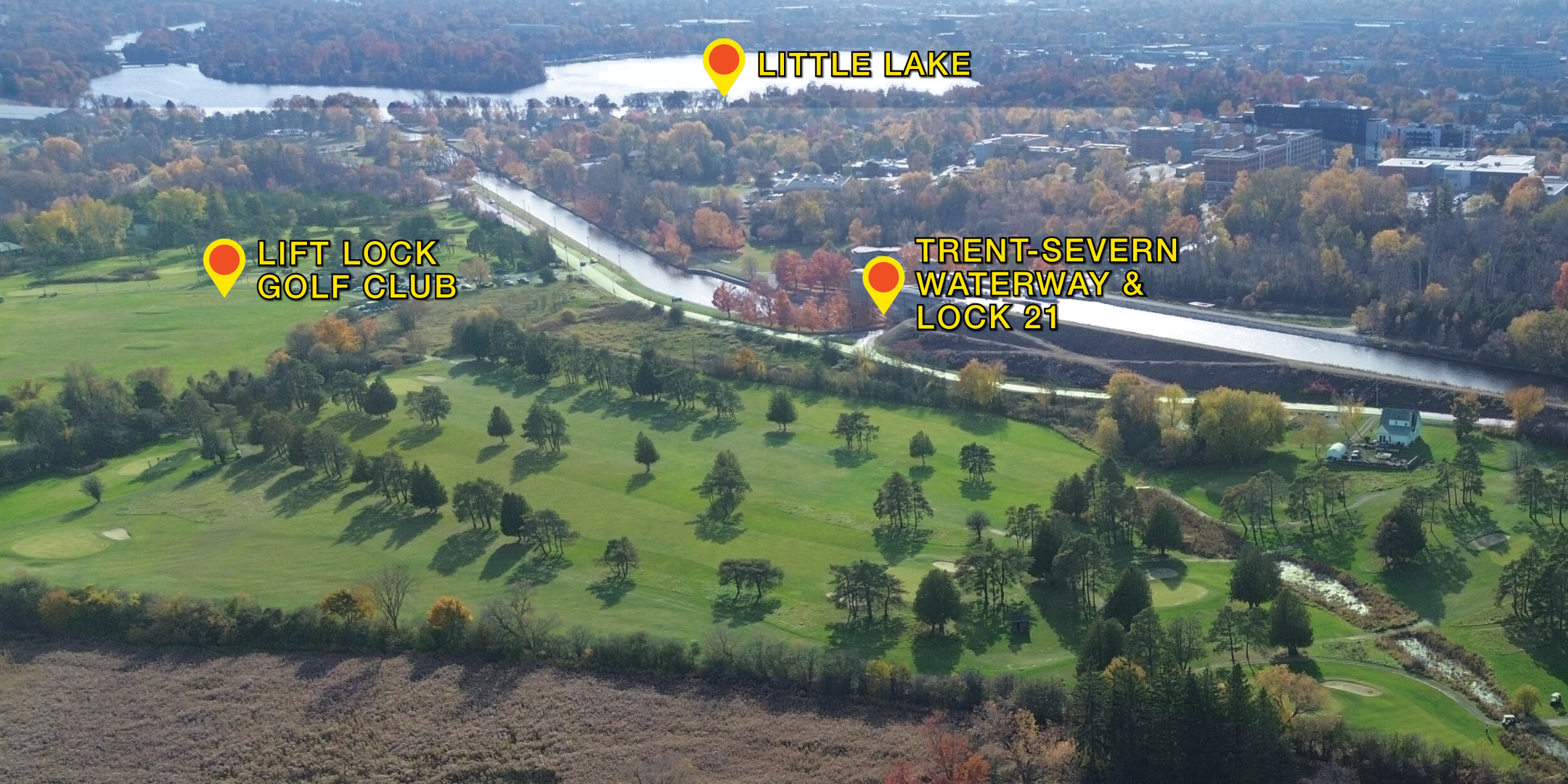 birds eye aerial of golf course showing river and lakes in background