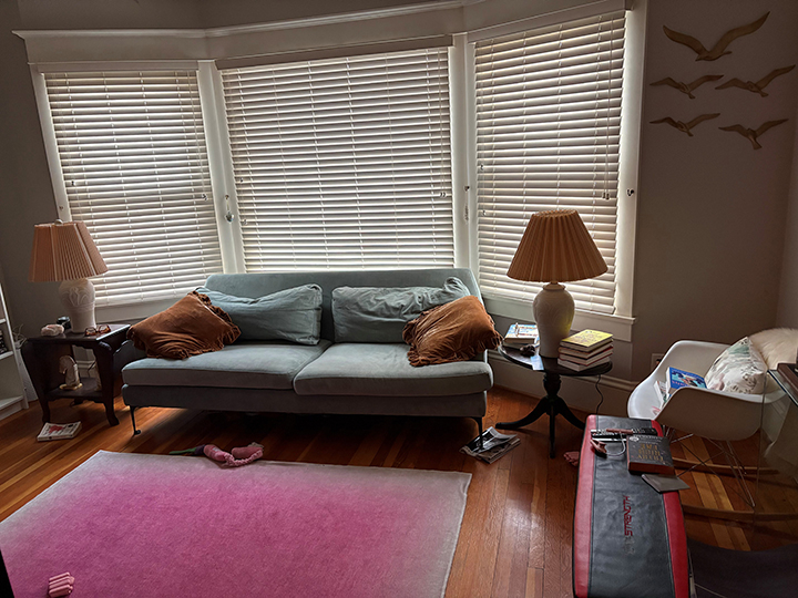 main living space of residential unit with sofa, floor lamps and carpet