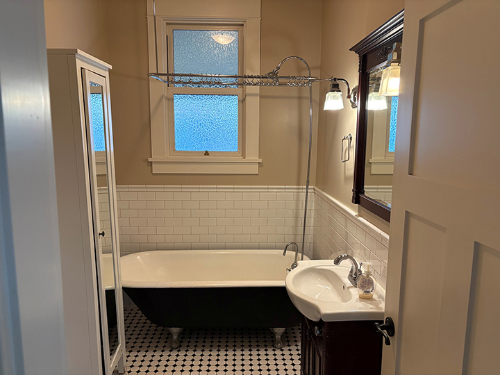 bathroom with checkered tile flooring, sing and bathtub