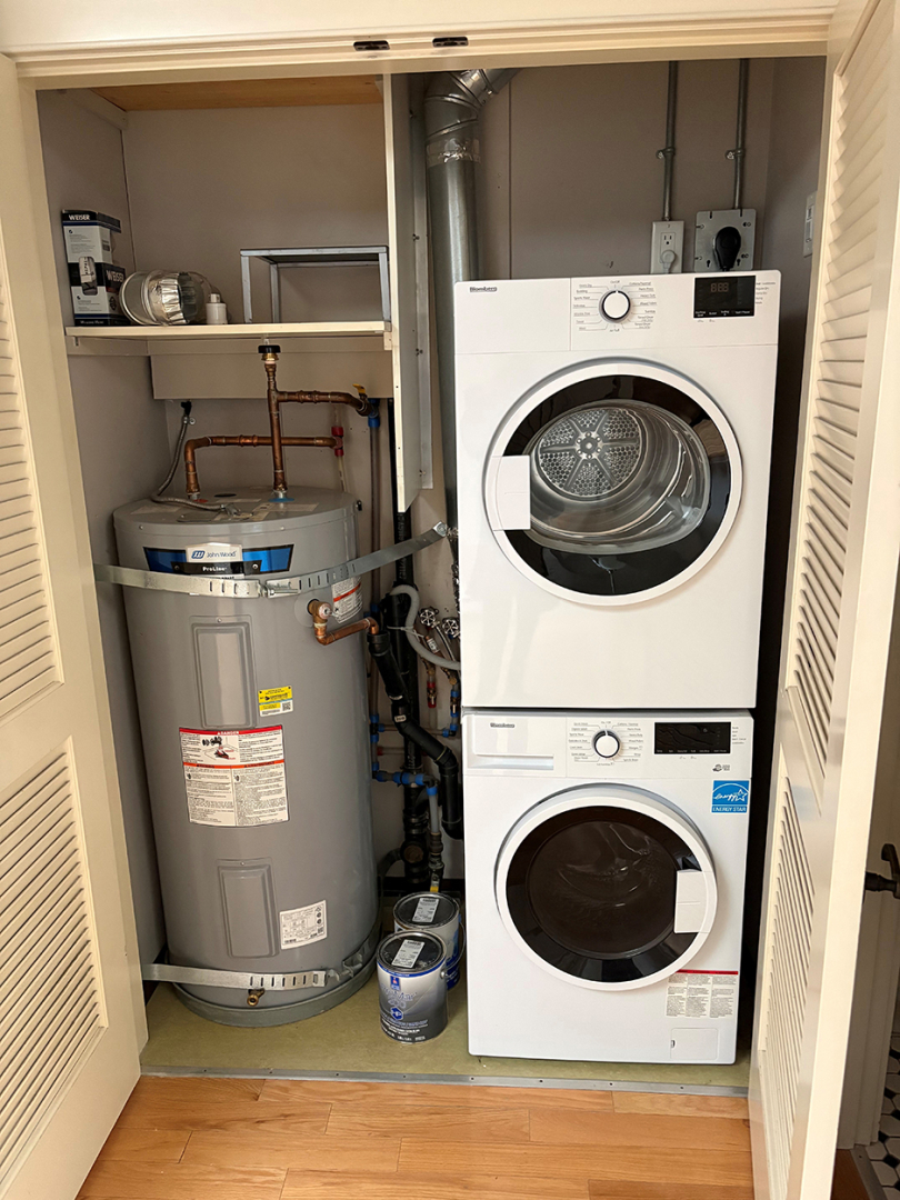 closet with washer, dryer and hot water tank