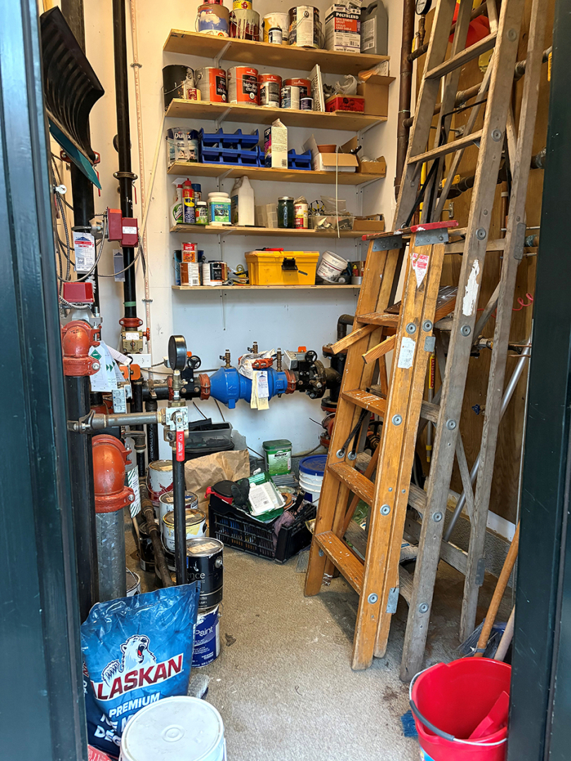 maintenance closet with ladders and equipment