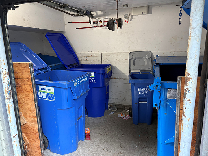 recycling room with 4 large blue containers