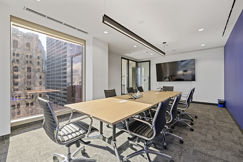 40 King St W interior view of the conference room with large desk and window and tv