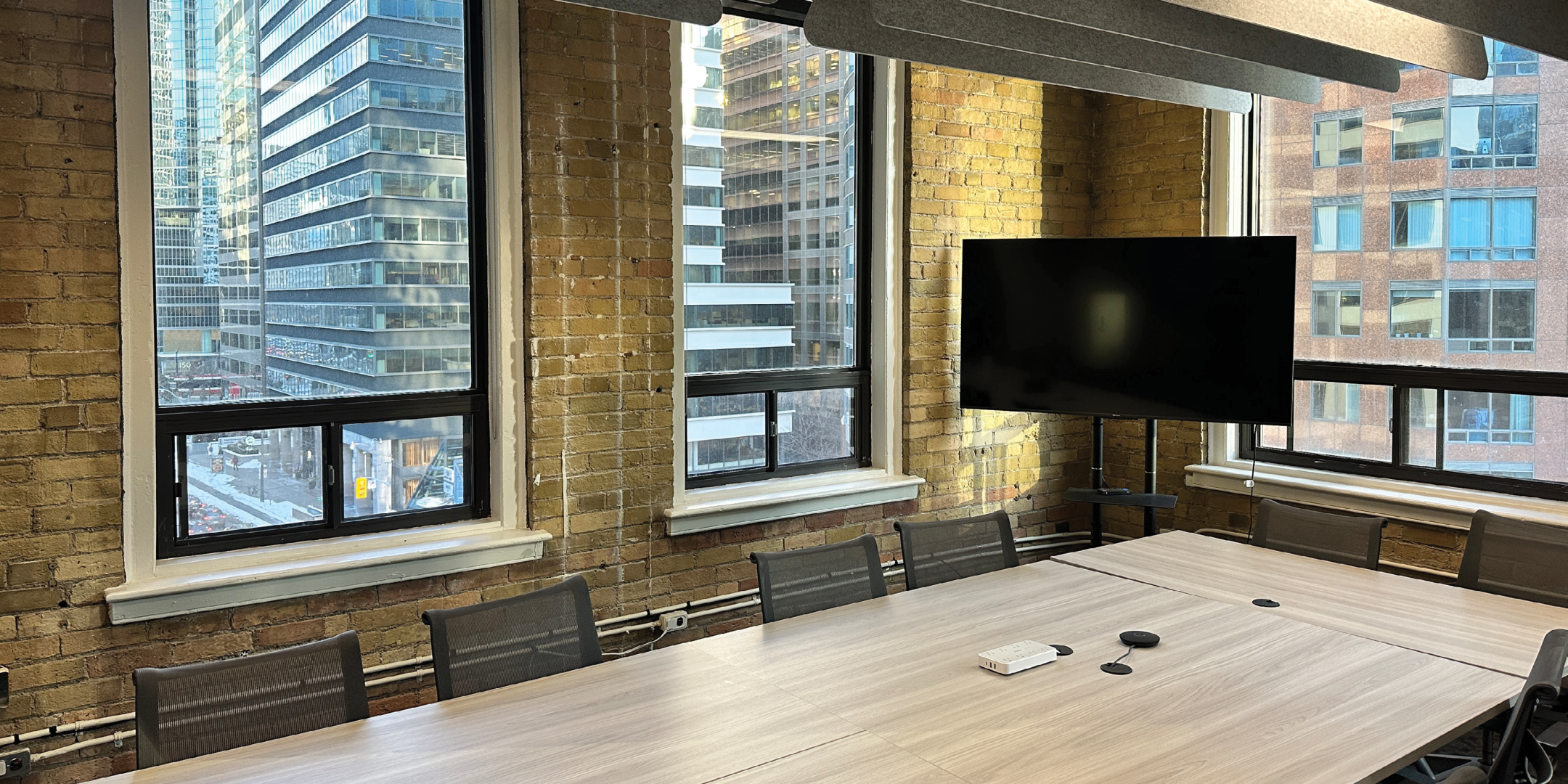 144 Front Street W meeting room with TV and windows
