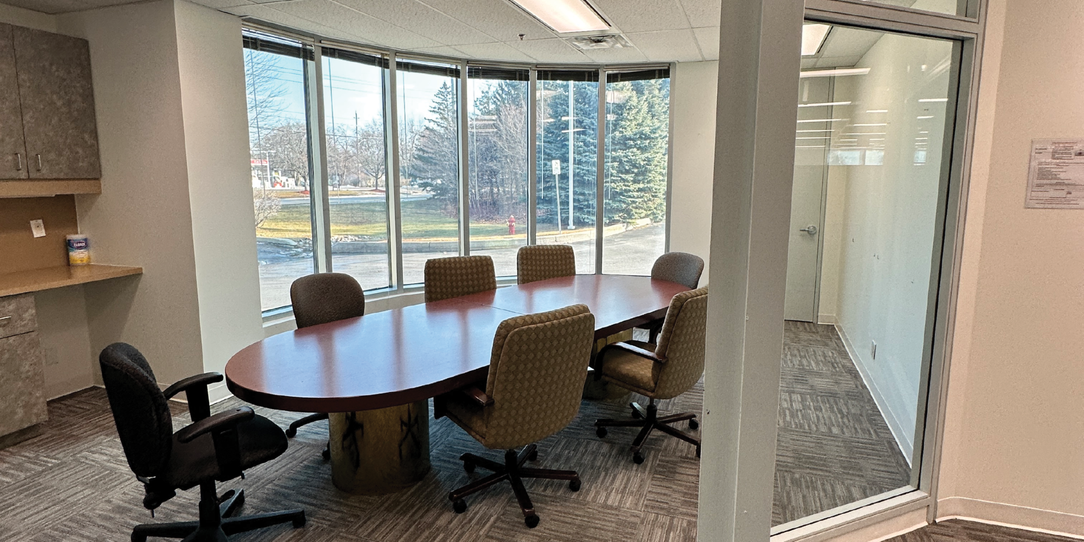 1540 Cornwall Road interior view of the meeting room with large desk and chairs.