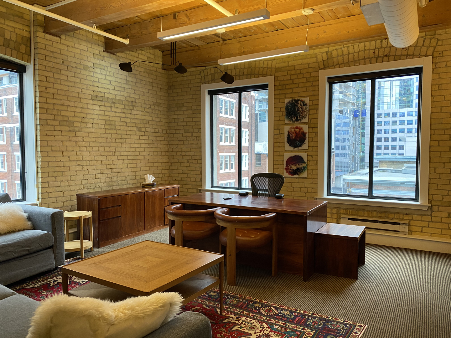 24 Duncan Street open space with big window overlooking the desks and sofa