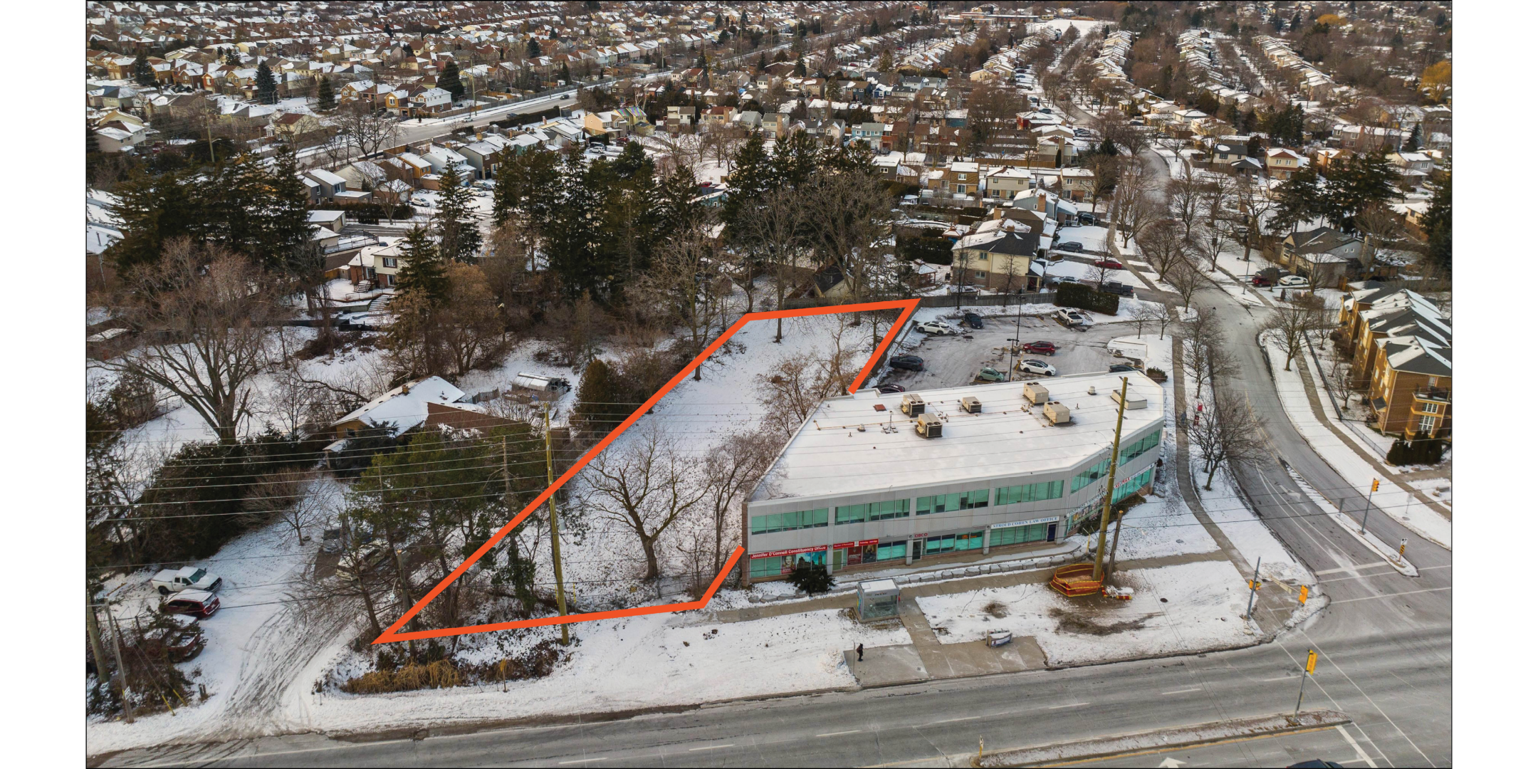 Aerial of front of the site with the parcel outlined in orange