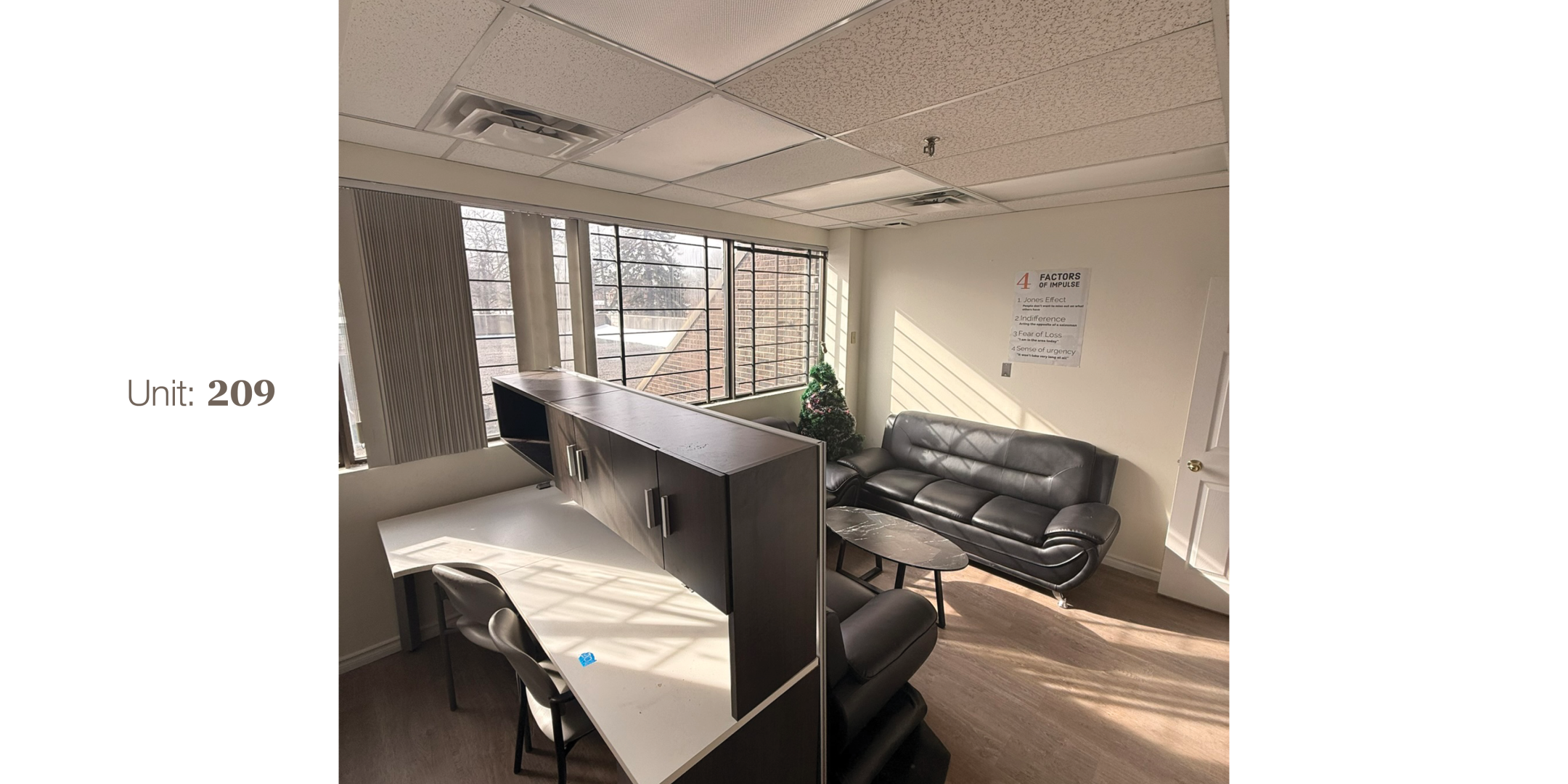 4433 Sheppard Avenue E Unit 209 Office Area with large windows, table, chairs and sofa