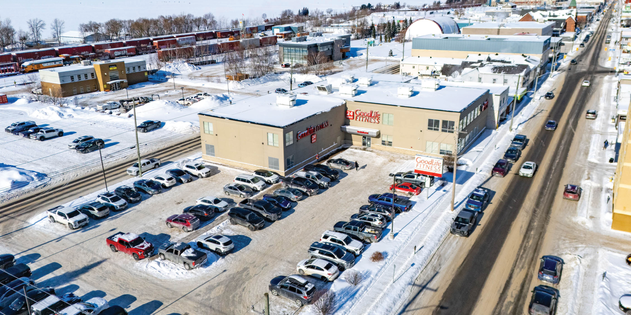 Aerial of Good Life Fitness Building and Parking lot with lots of vehicles in parking lot