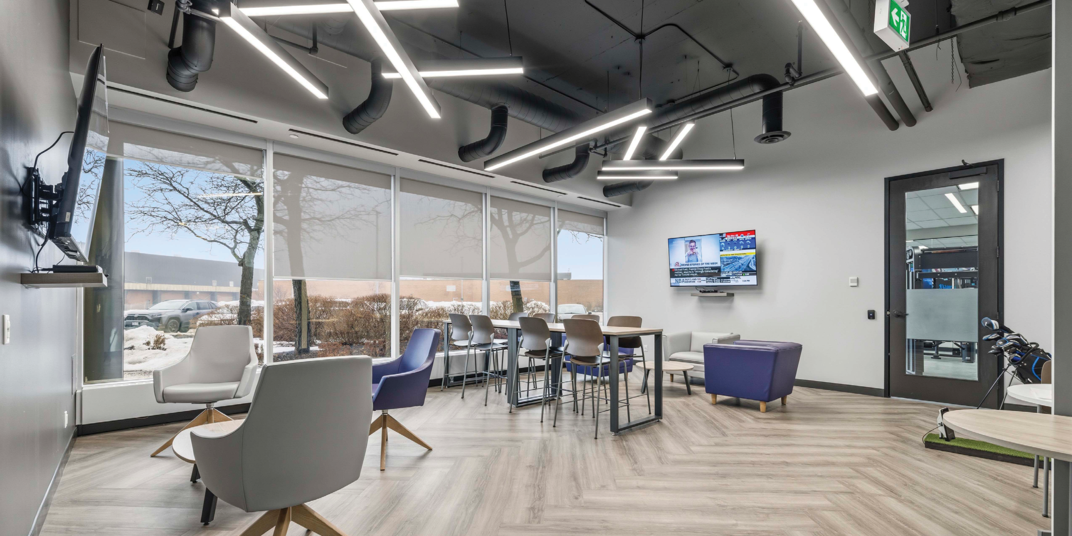 600 Cochrane Drive Unit 205 Lounge With White Chairs And TV