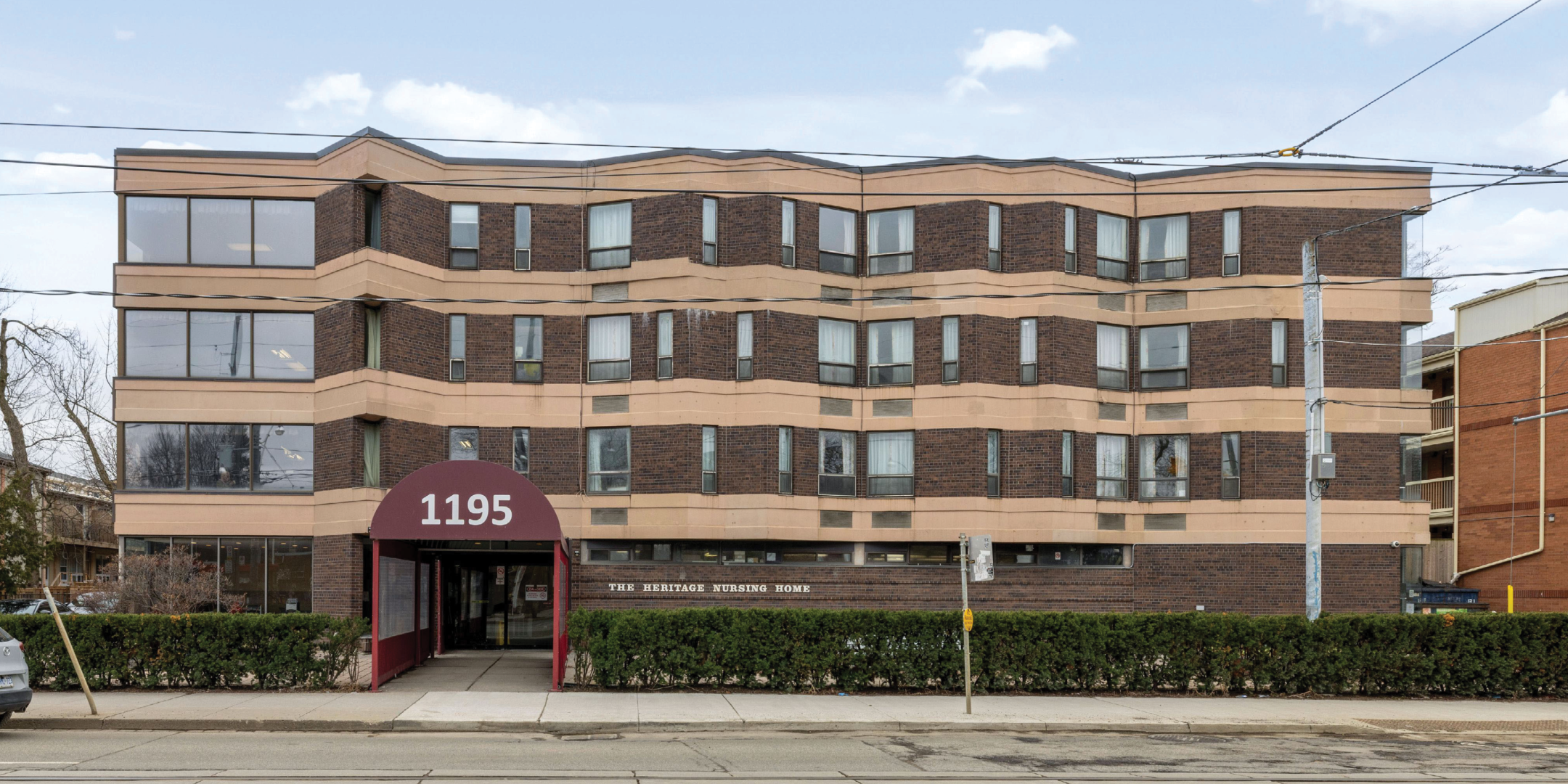 1195 Queen Street E exterior view of the whole building and the entrance