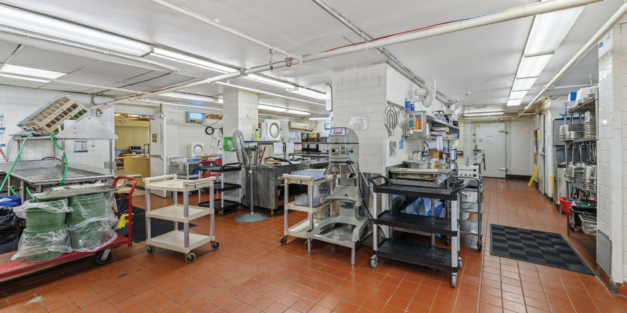 1195 Queen Street E commercial kitchen with equipment and prep area