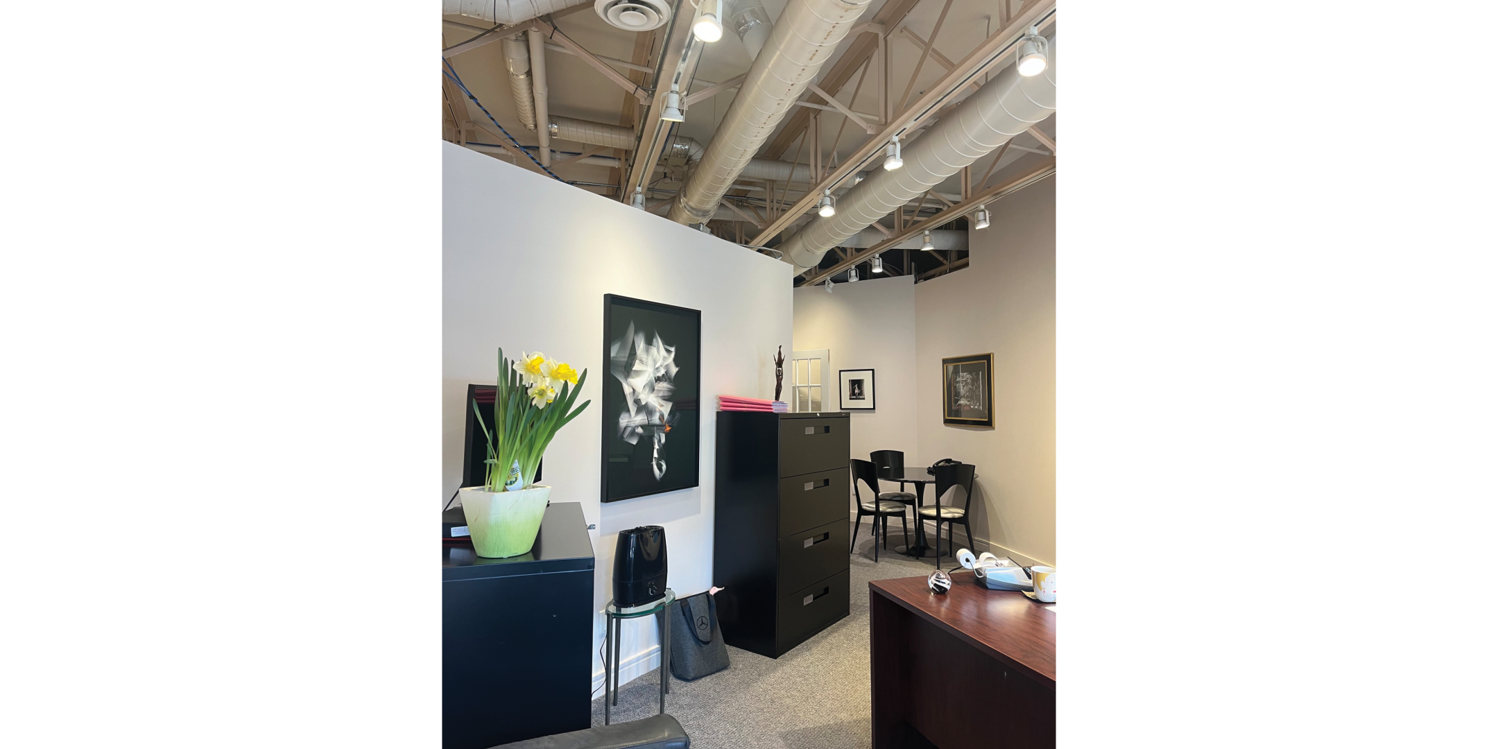 225 Macpherson Avenue includes a furnished office area with exposed ceilings and artwork.