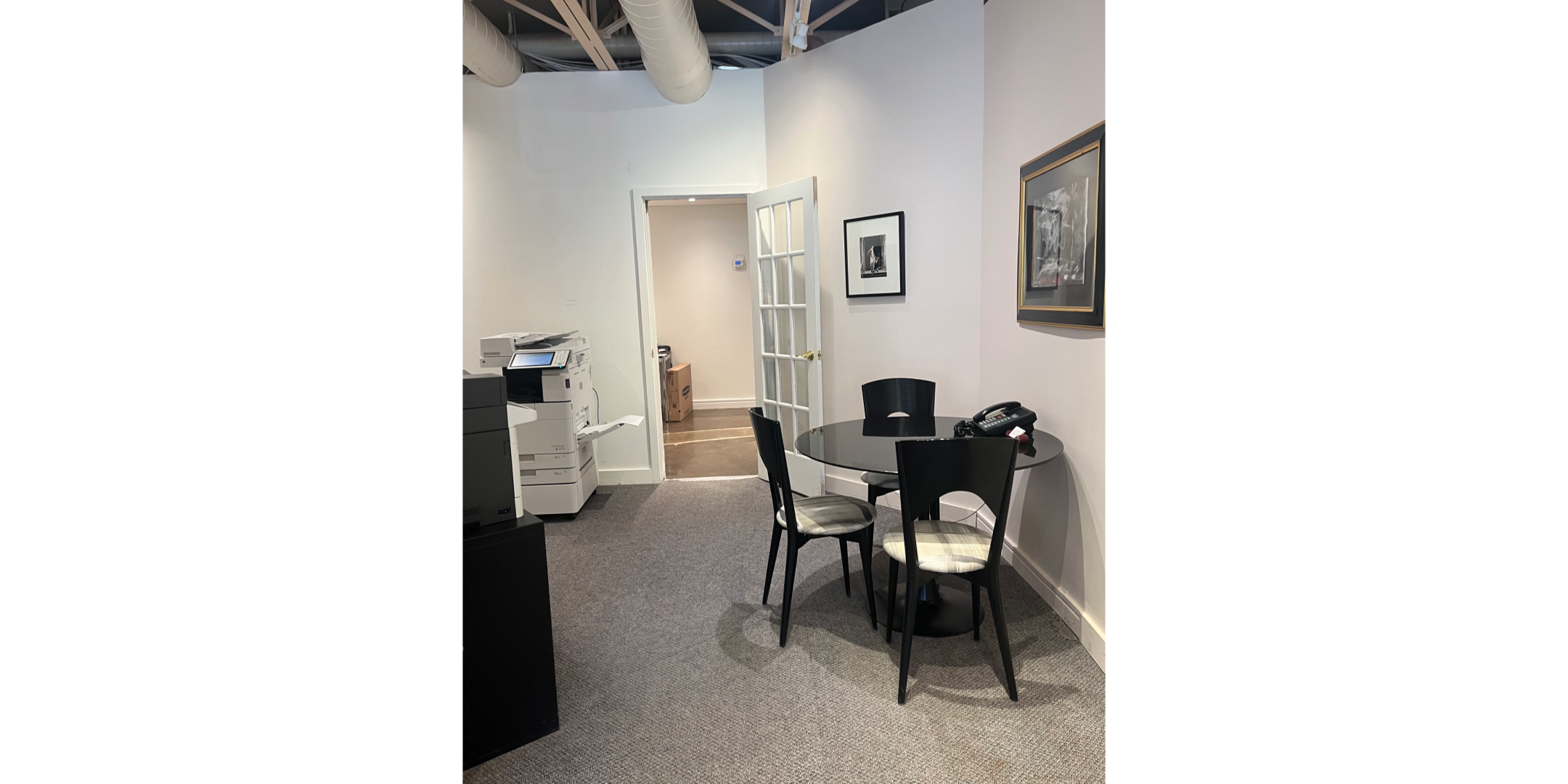 225 Macpherson Avenue features a small meeting area with seating and printer space.