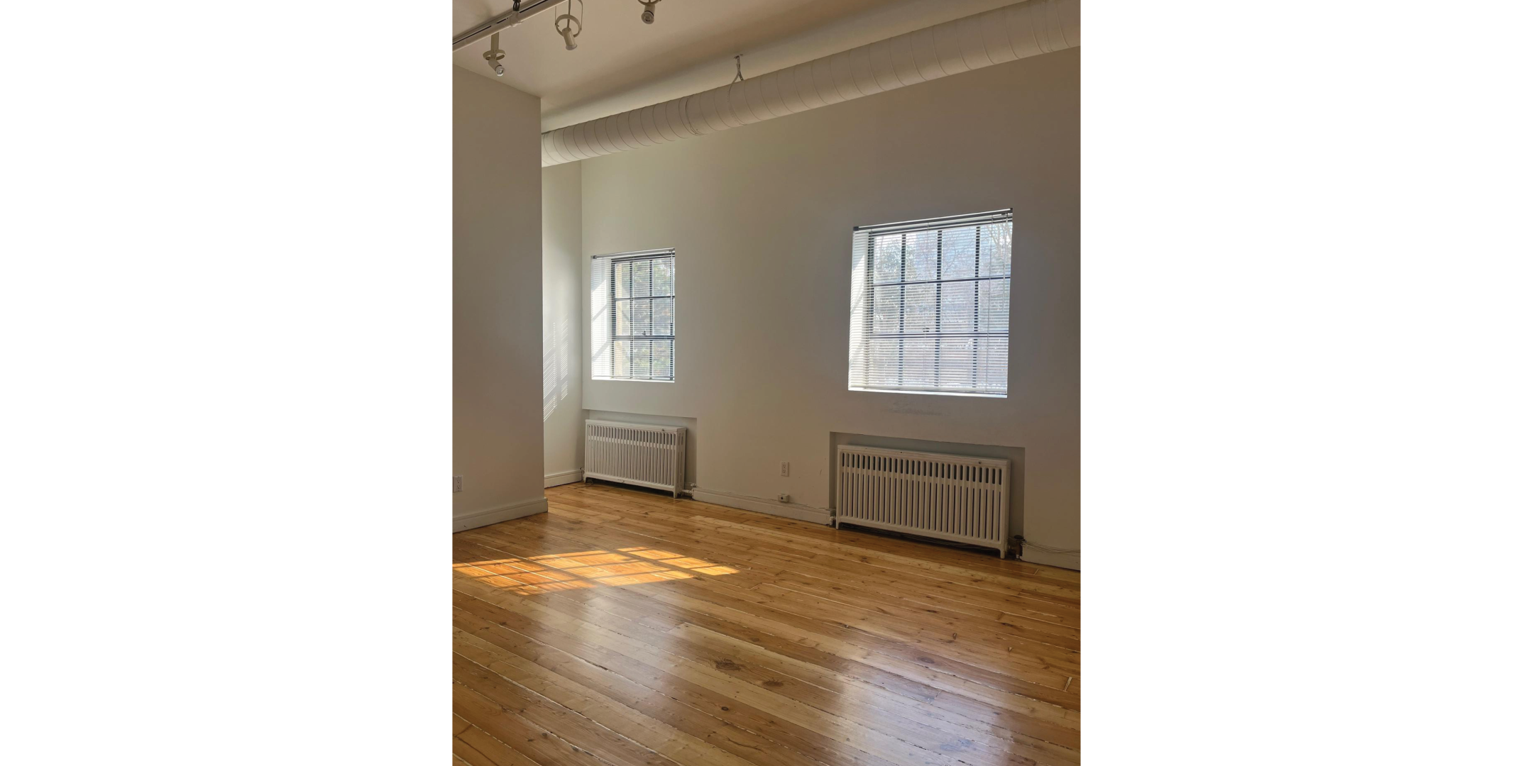 225 Macpherson Avenue provides an open room with hardwood floors and natural light.