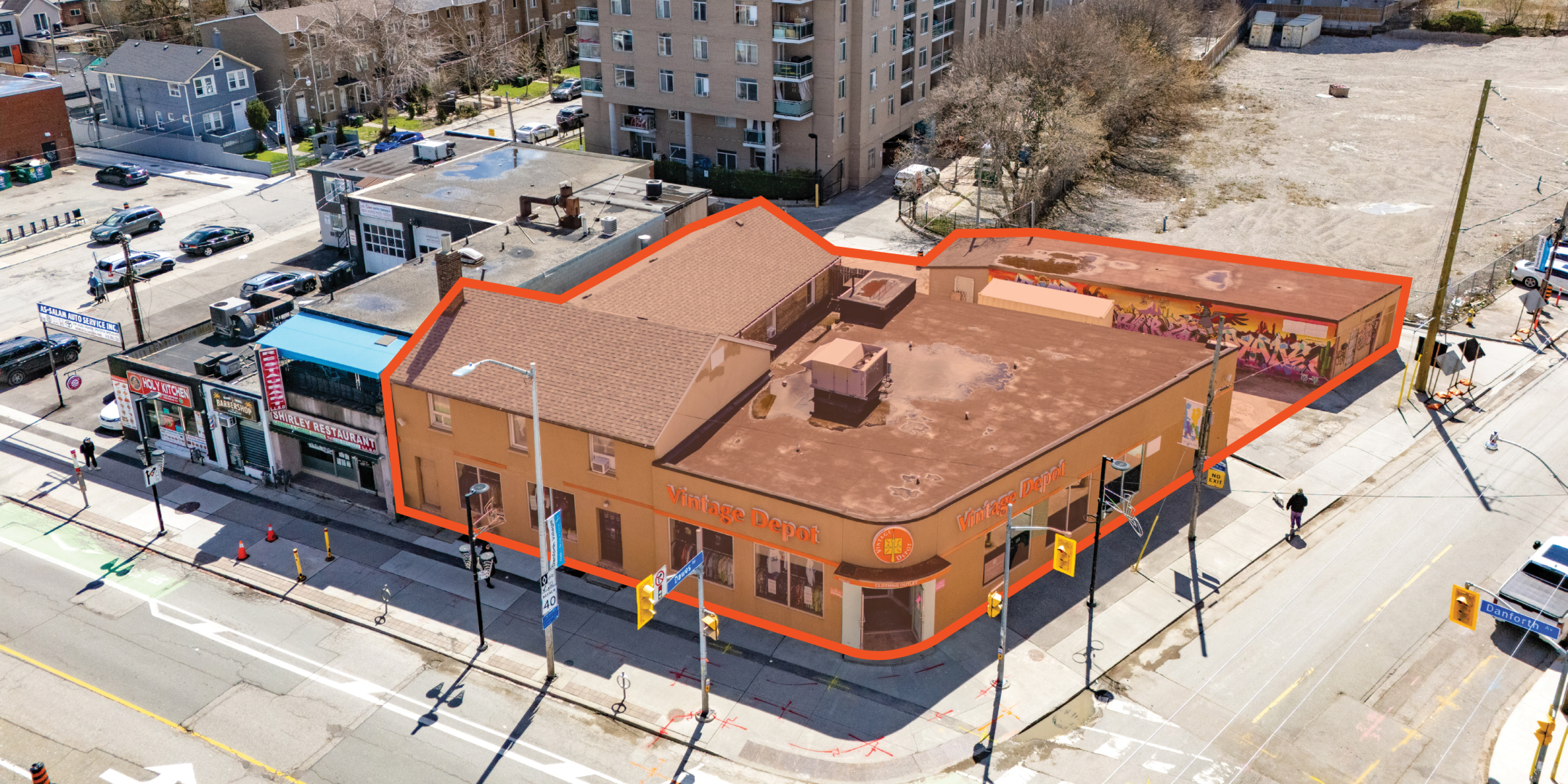 2777 Danforth Avenue Angled exterior drone view of the outlined commercial building on a busy street corner