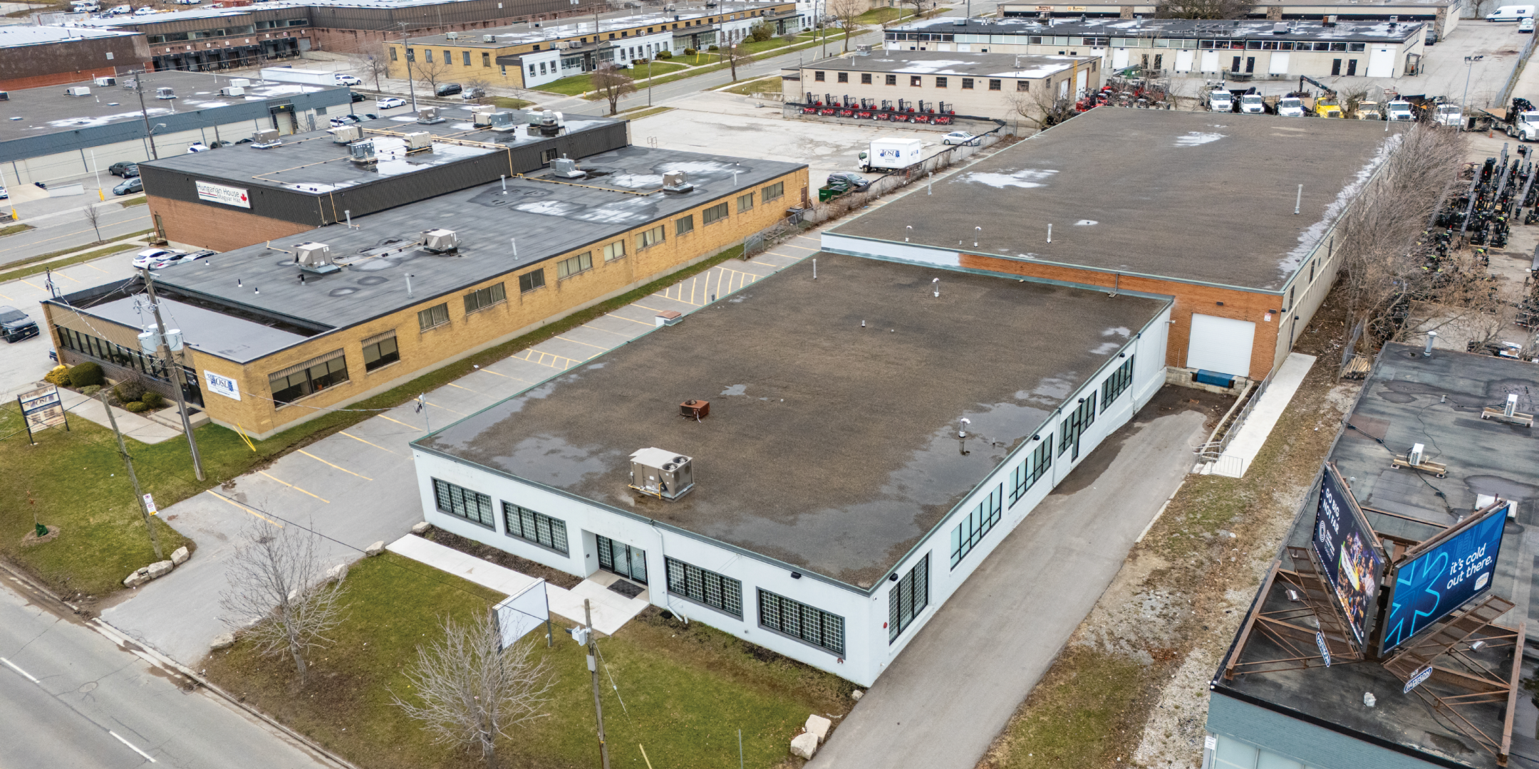30 Bermondsey Road aerial view of a low-rise industrial building with adjacent parking and surrounding warehouses
