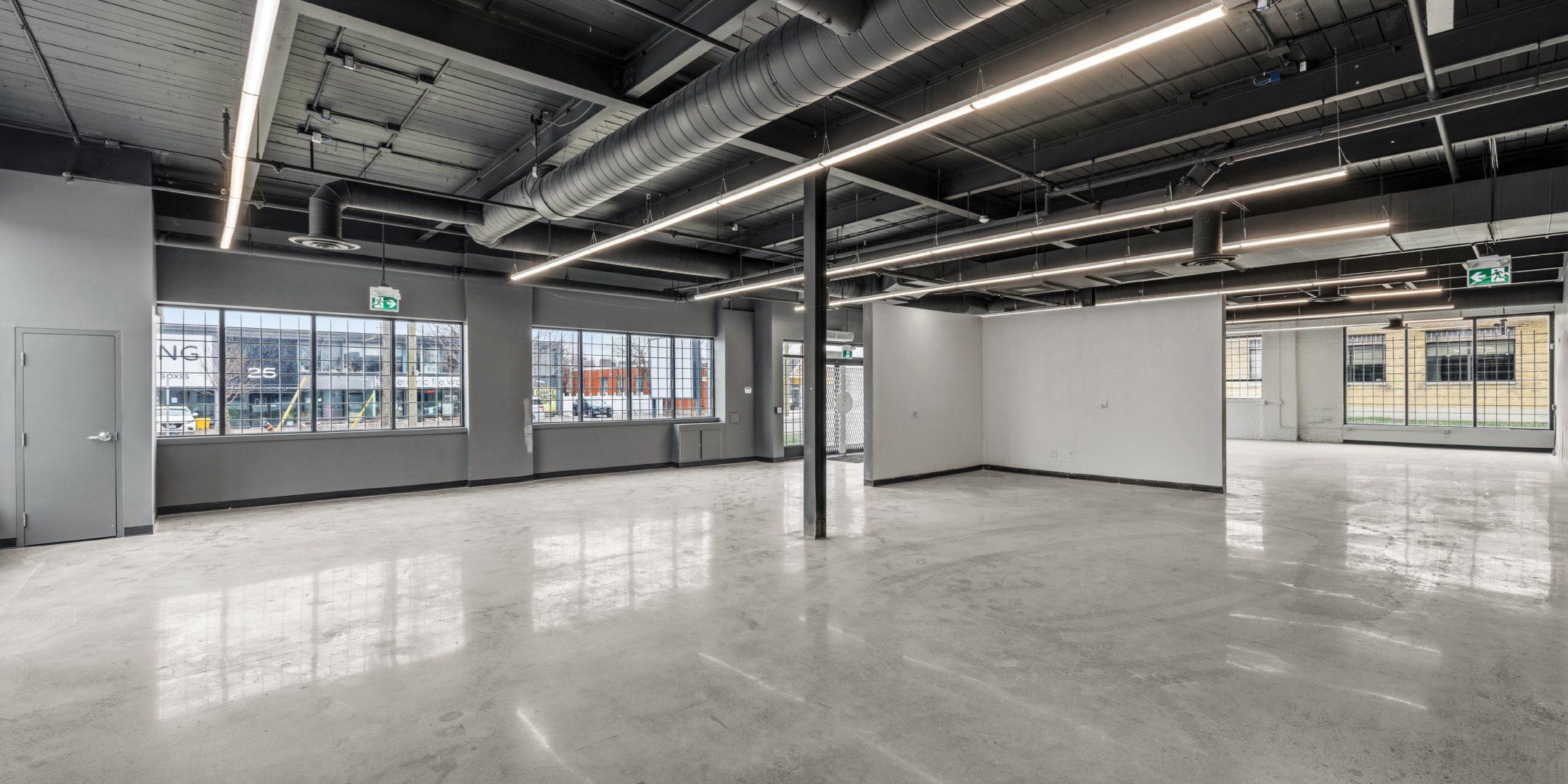 30 Bermondsey Road bright showroom with exposed industrial ceilings and concrete floor