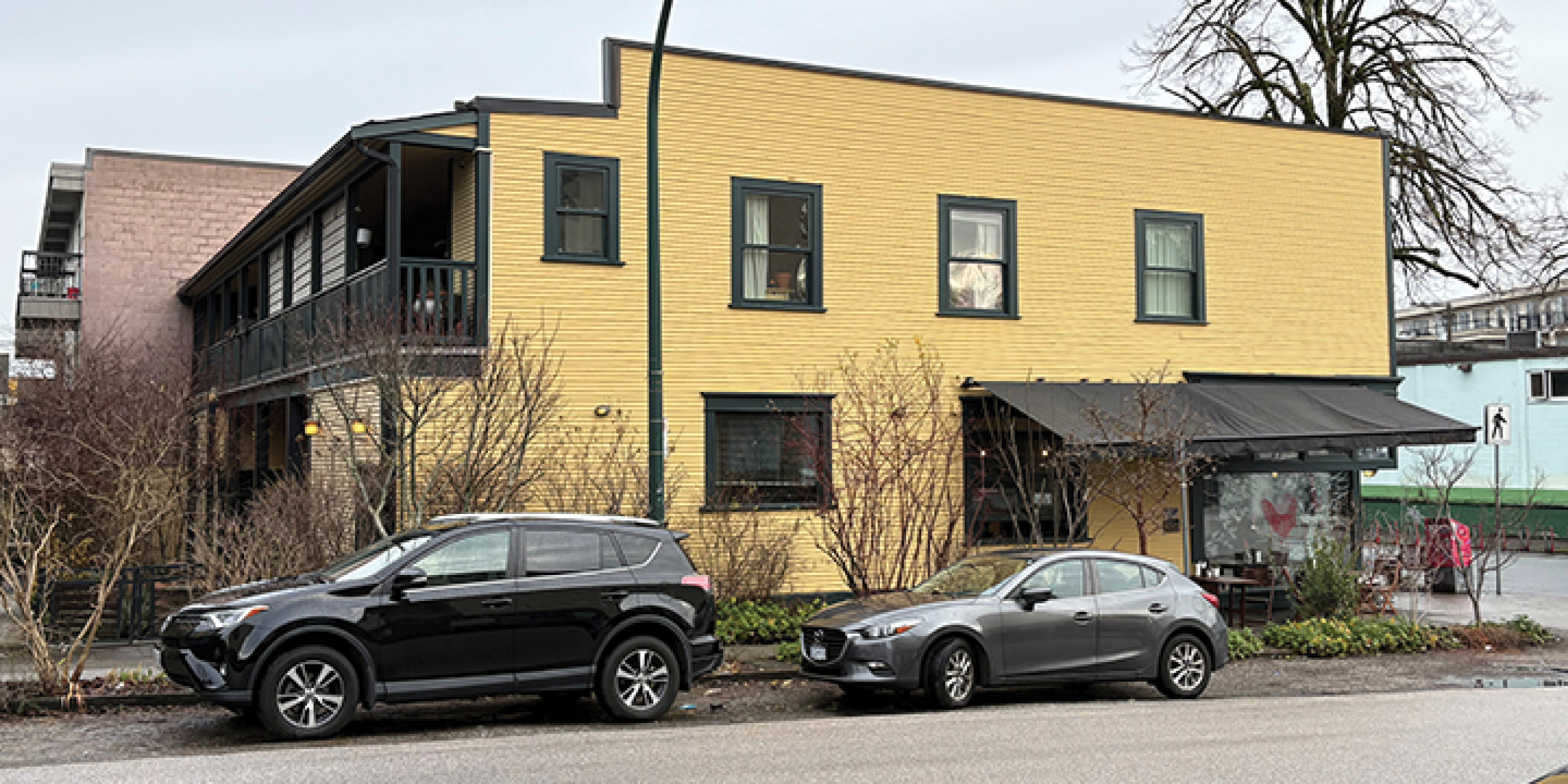 3589-3599 Commercial Street building exterior showing side and back, including upper balcony