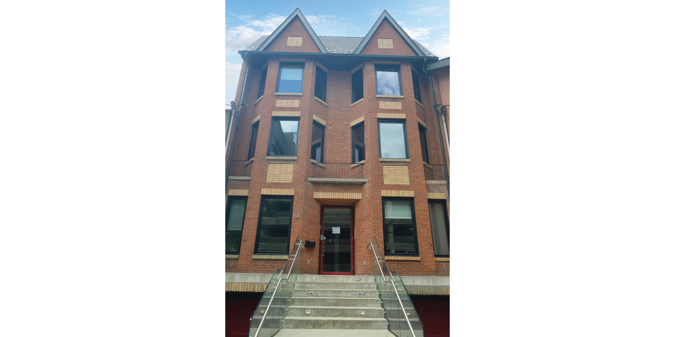 Photo of 3 story office building with red brick