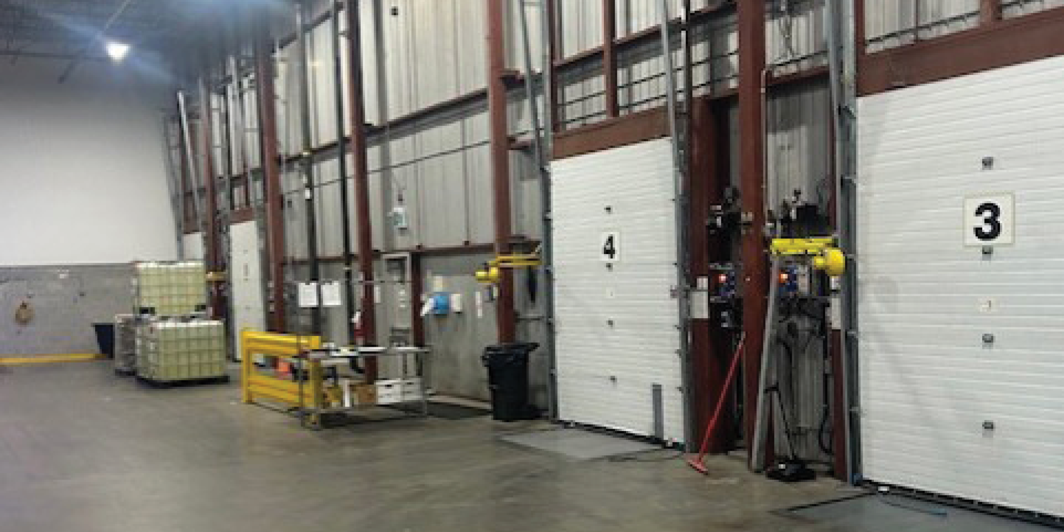 7680 Tranmere Drive Interior warehouse loading dock with numbered overhead doors.