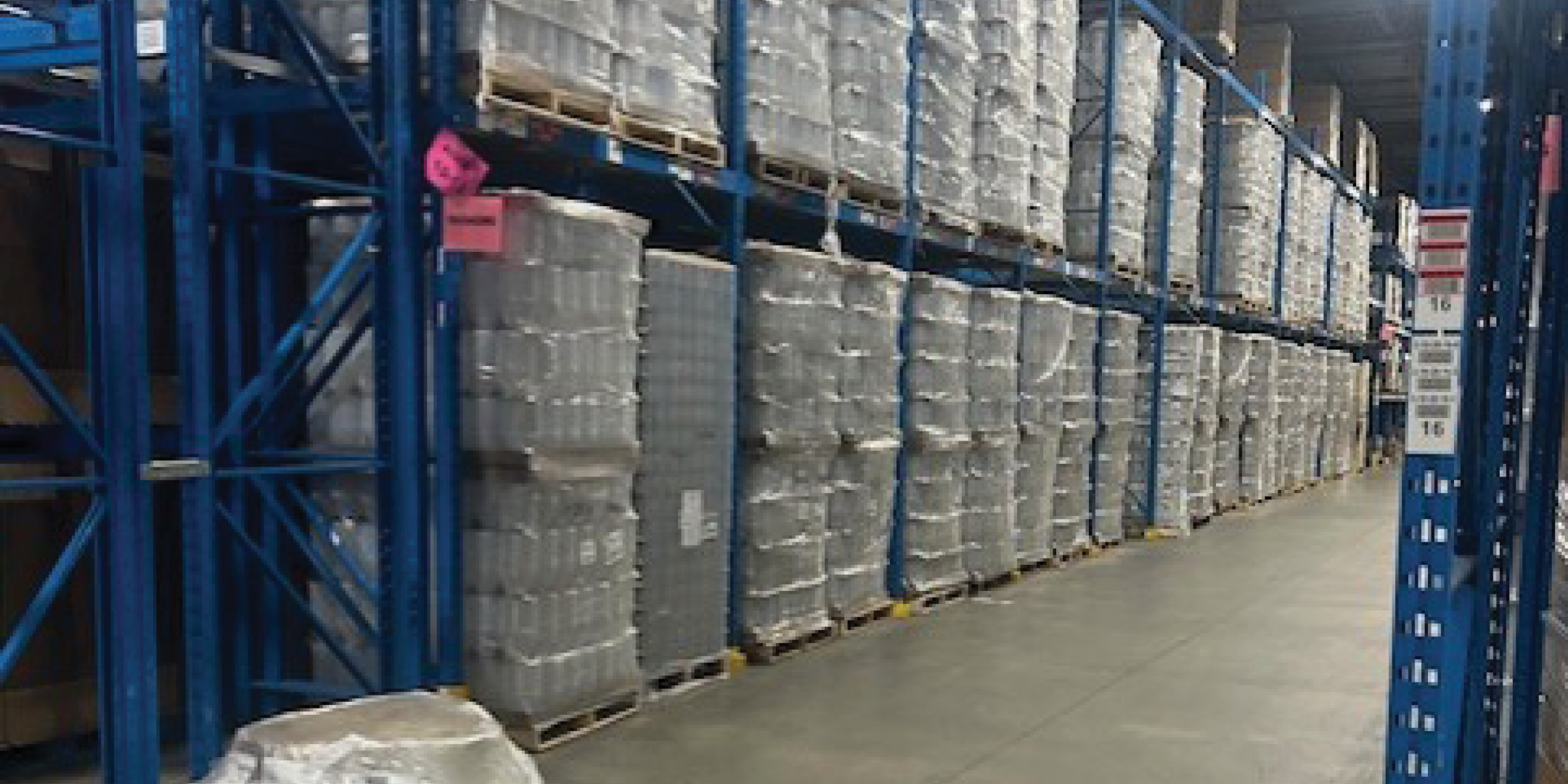 7680 Tranmere Drive Warehouse aisle with high pallet racking and stored goods.