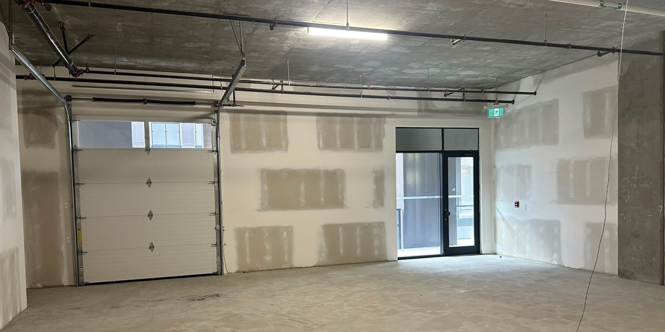 One (1) grade loading door with access to shared loading area with dock and grade loading