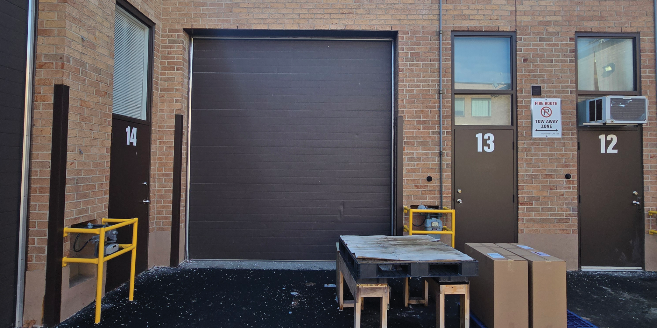 90 Winges Road Unit 13 back exterior showing back door and drive-in door