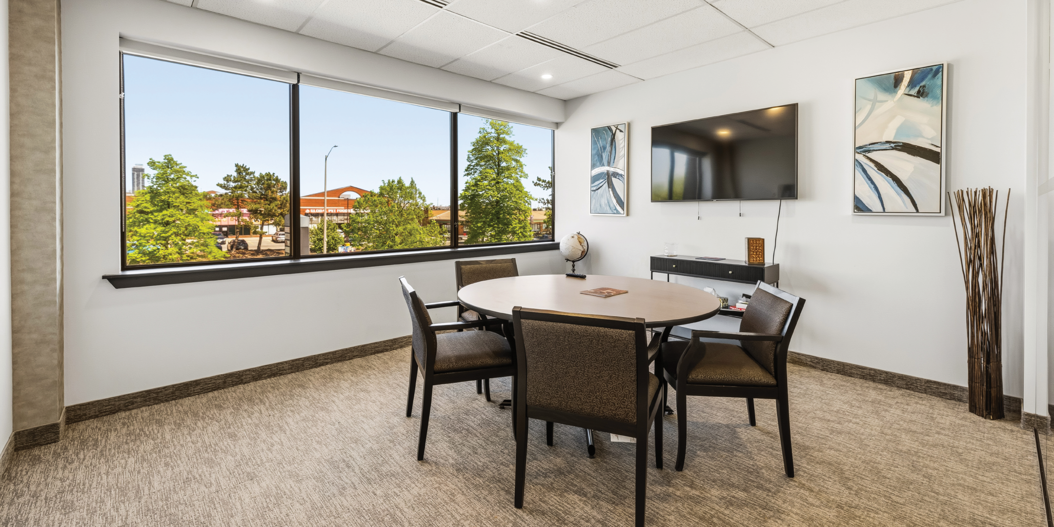 1270 Central Parkway W meeting room with round table and large windows