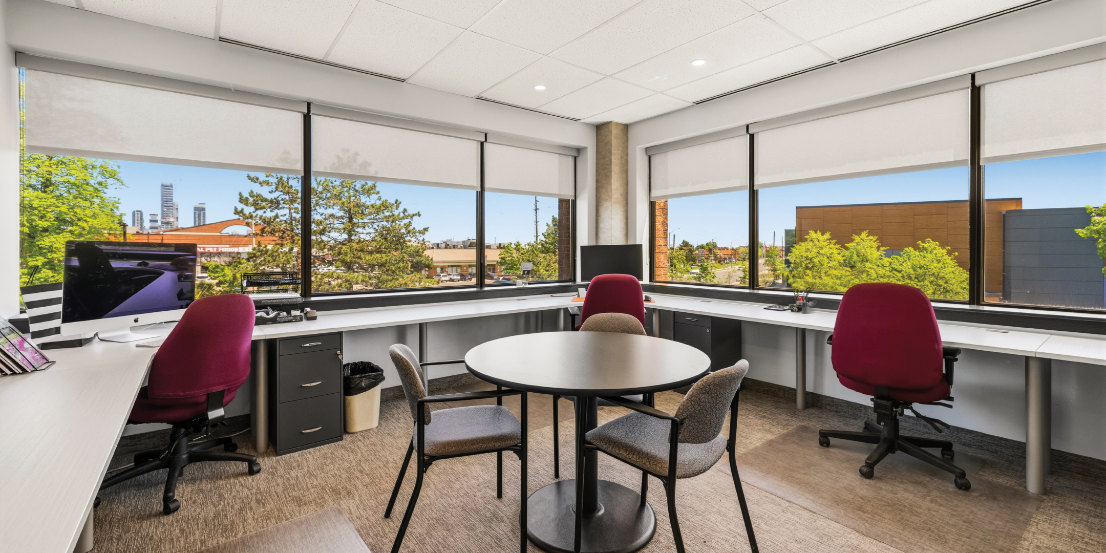 1270 Central Parkway W shared office area with round meeting table